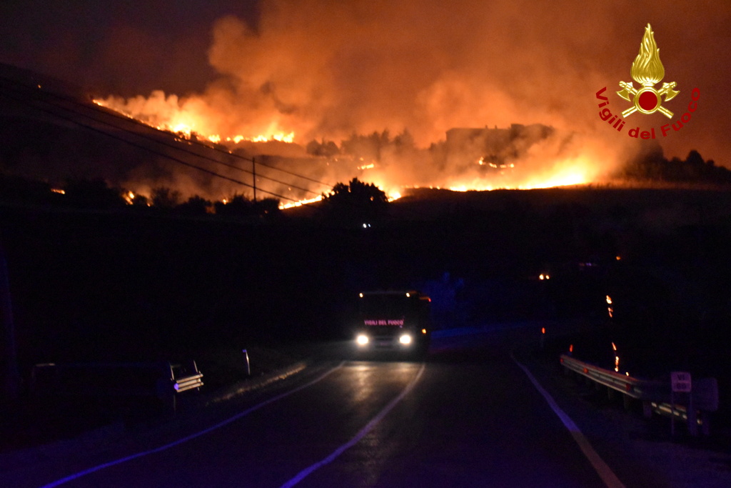 A hillside is engulfed in flames as a wildfire burns in Petralia Soprana, Italy August 10, 2021. Picture taken August 10, 2021. Vigili del Fuoco