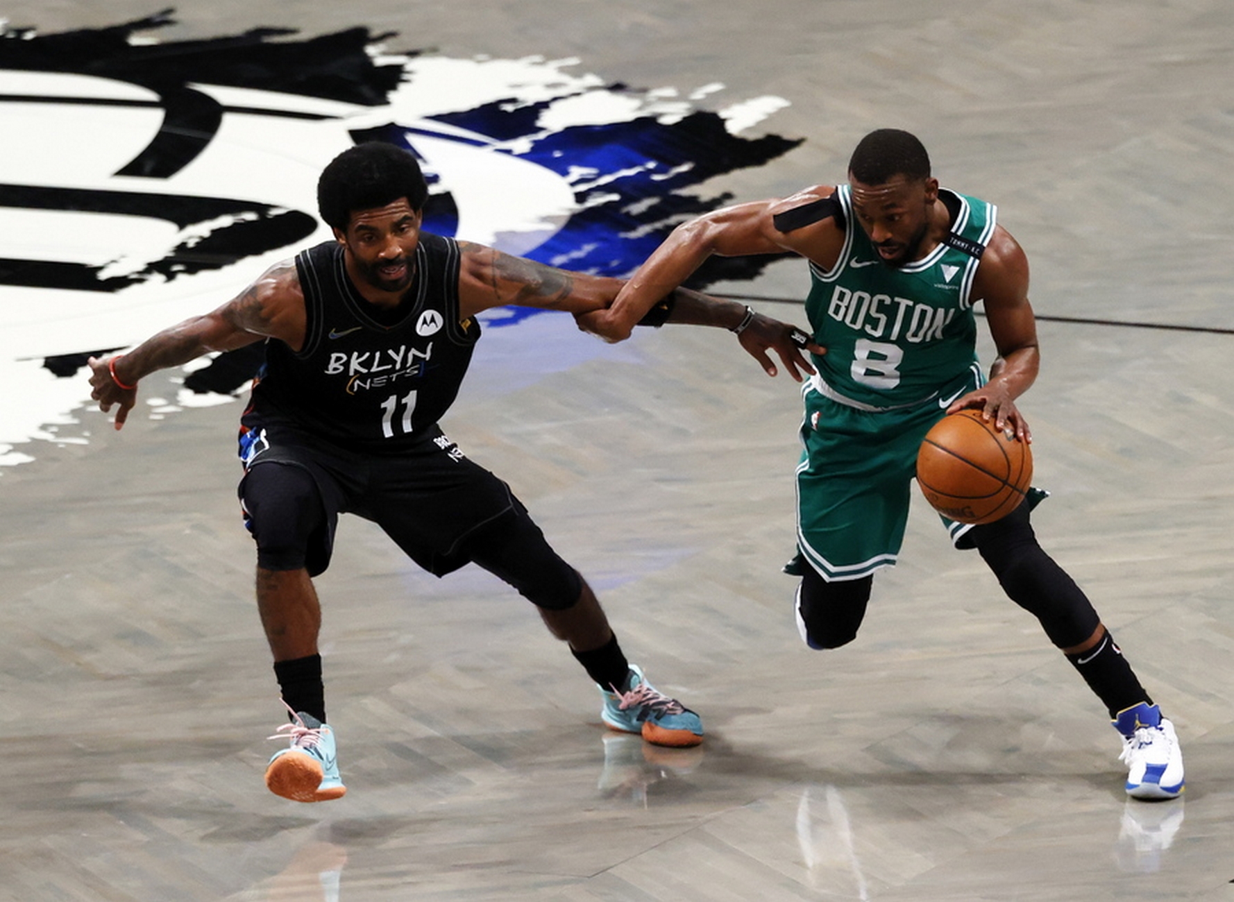 epa09227967 Boston Celtics guard Kemba Walker (R) tries to drive around a defending Brooklyn Nets guard Kyrie Irving (L) during the first half of game two of the NBA playoffs basketball game between the Boston Celtics and the Brooklyn Nets at the Barclays Center in Brooklyn, New York, USA, 25 May 2021.  EPA