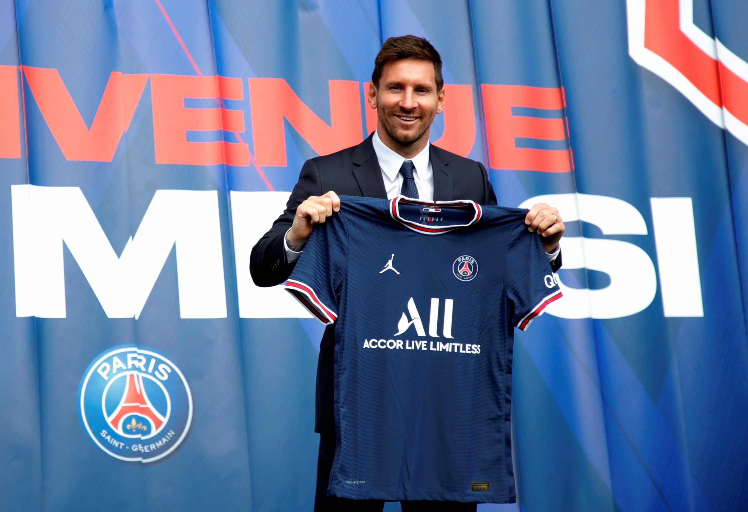 Soccer Football - Lionel Messi Press Conference after signing for Paris St Germain - Parc des Princes, Paris, France - August 11, 2021 Paris St Germain's Lionel Messi poses with a shirt on the pitch after the press conference REUTERS