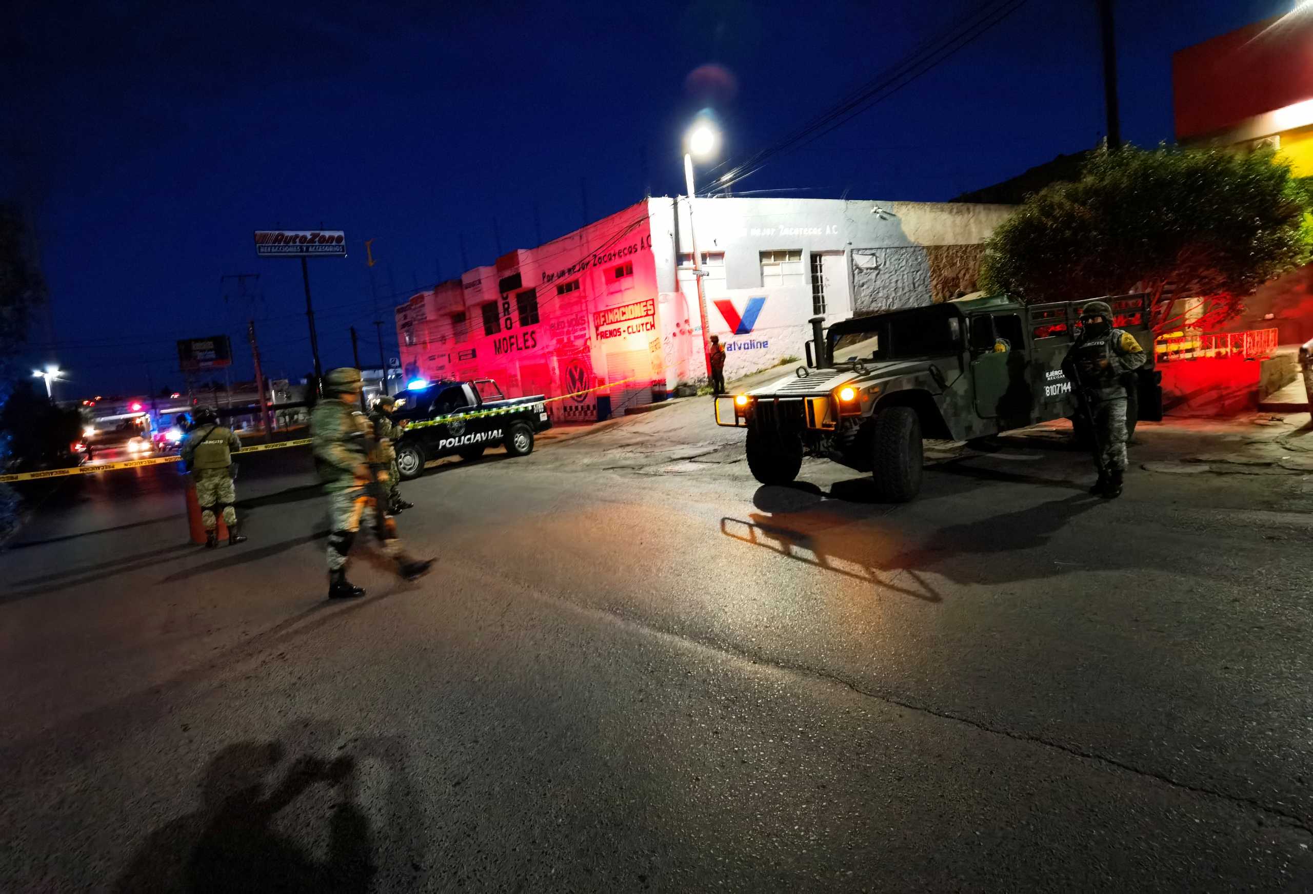Police secure an area after bodies of men were found hung up on a local overpass bridge in the city of Zacatecas in north-central Mexico, in this August 12, 2021 picture obtained from social media. TESTIGO OCULAR NOTICIAS