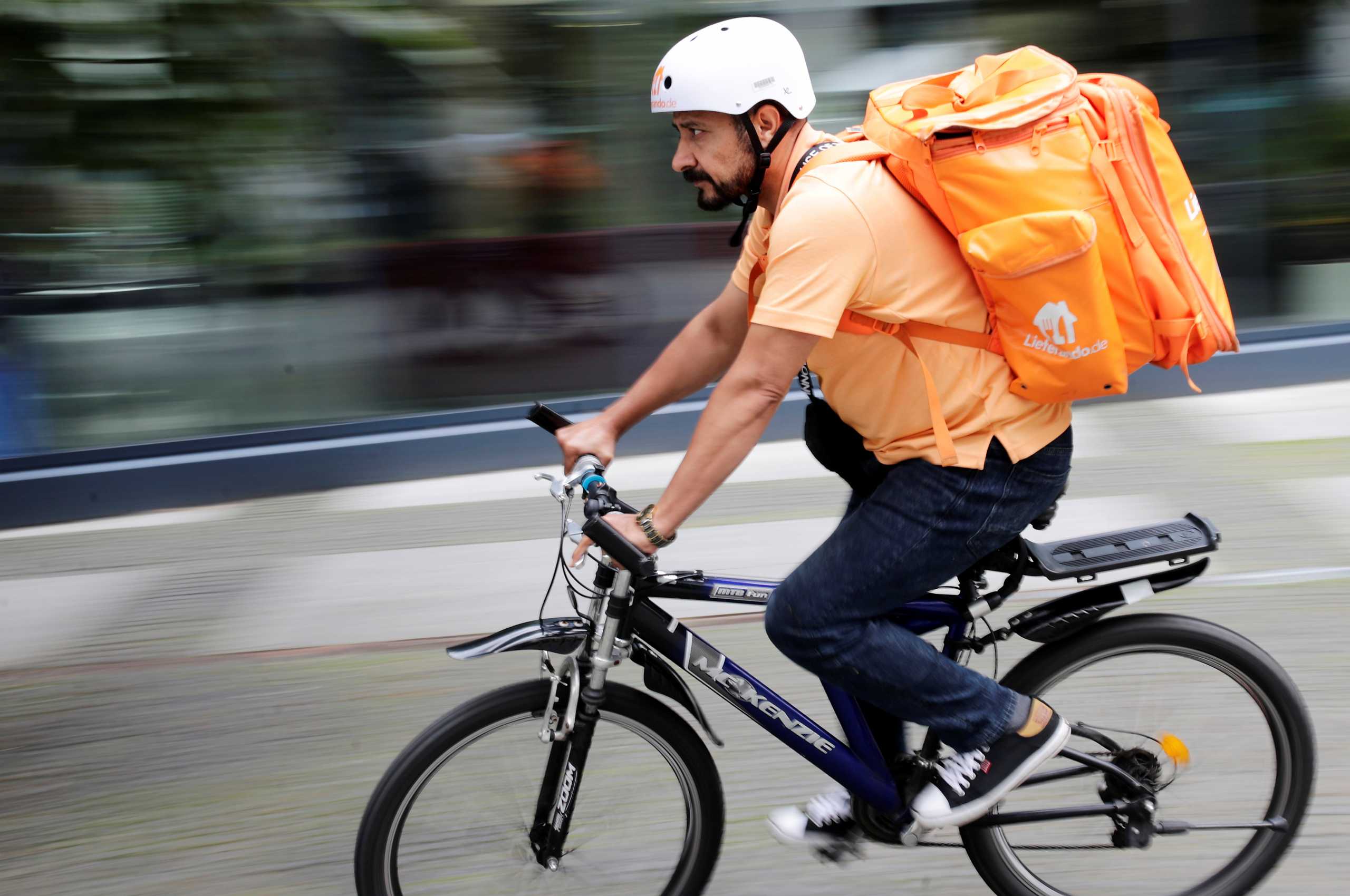 Former Afghan Communication Minister Sayed Sadaat rides a bicycle for his food delivery service job with Lieferando in Leipzig, Germany, August 26, 2021. REUTERS