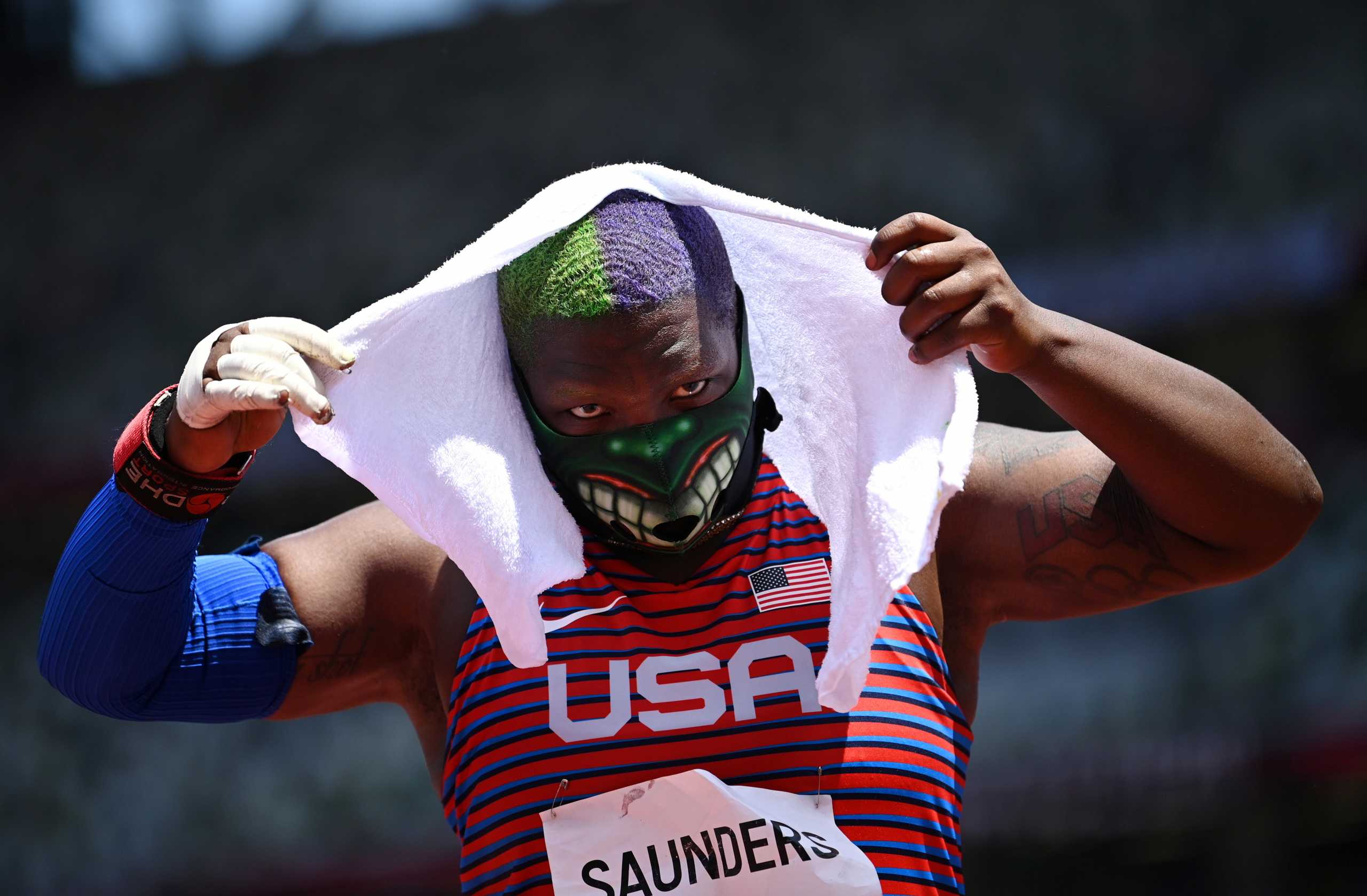 Tokyo 2020 Olympics - Athletics - Women's Shot Put - Final - OLS - Olympic Stadium, Tokyo, Japan – August 1, 2021. Raven Saunders of the United States wearing a protective face mask adjusts the towel on her head REUTERS