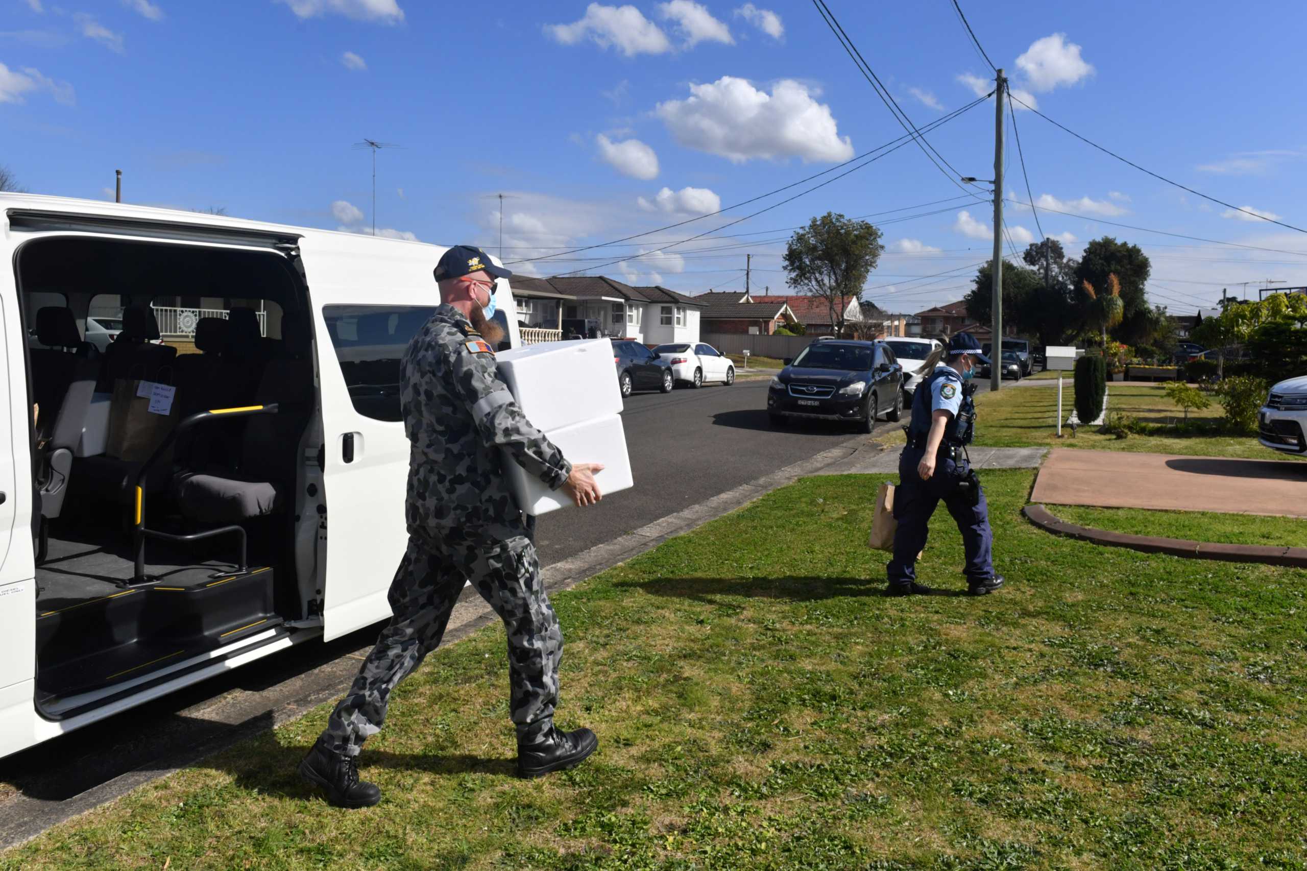 Australian Defence Force personnel and NSW police deliver emergency food parcels for people in lockdown in the Fairfield suburb in the southwest of Sydney, Australia, August 2, 2021.  AAP Image