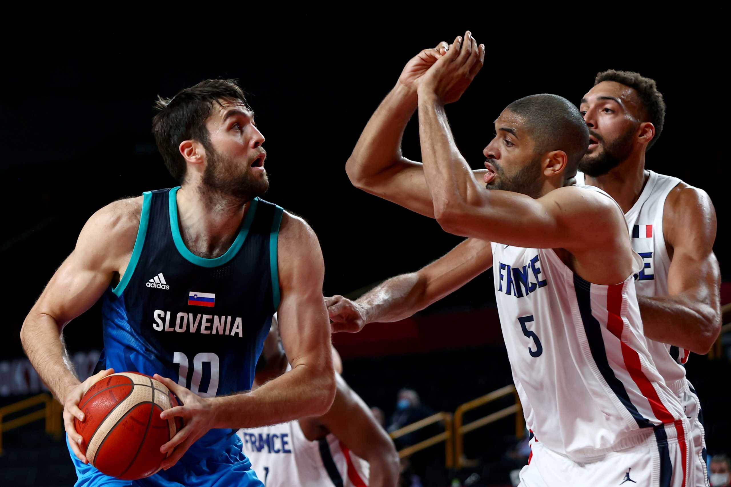 Tokyo 2020 Olympics - Basketball - Men - Semifinal - France v Slovenia - Saitama Super Arena, Saitama, Japan - August 5, 2021. Mike Tobey of Slovenia in action with Nicolas Batum of France REUTERS