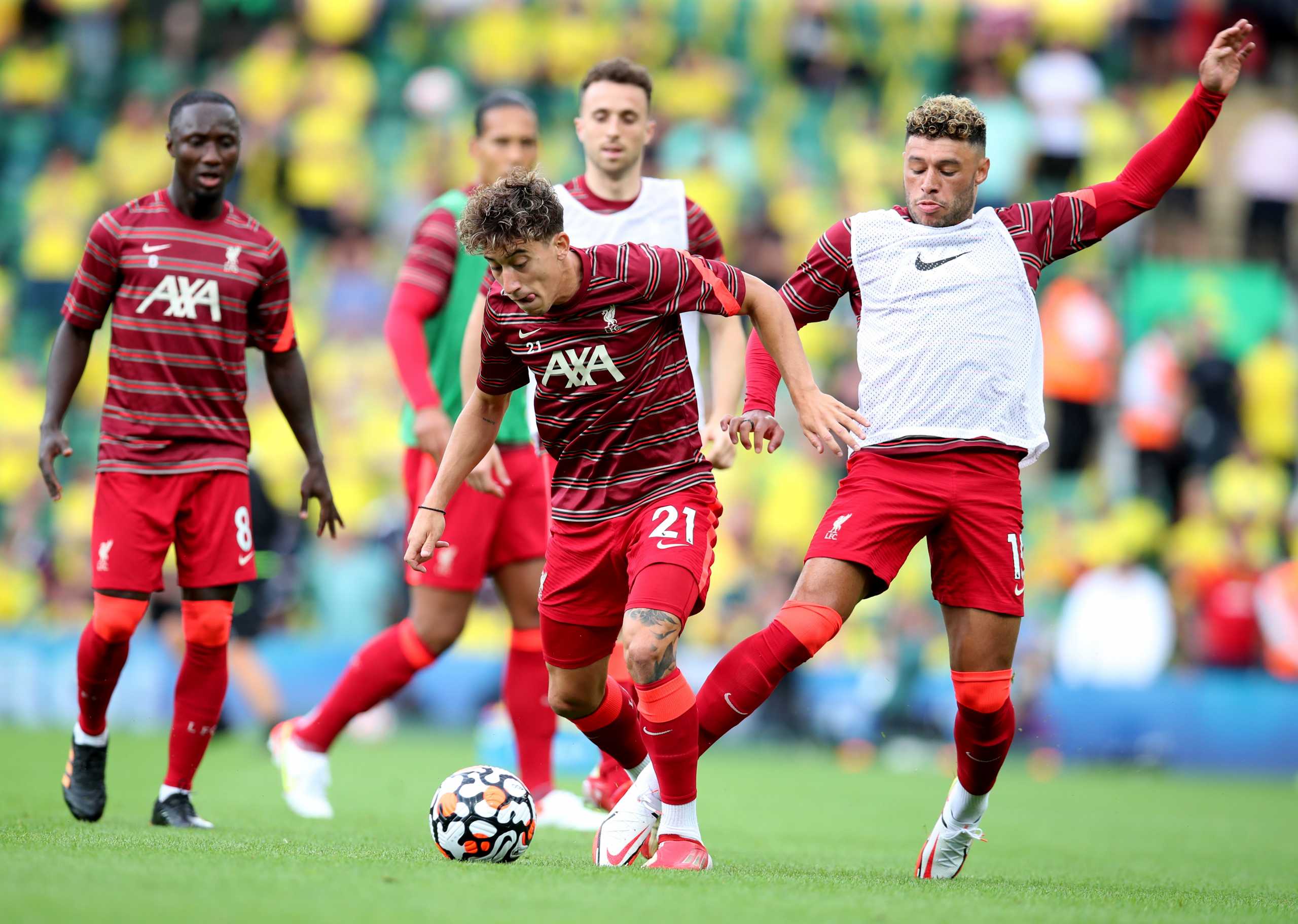 Soccer Football - Premier League - Norwich City v Liverpool - Carrow Road, Norwich, Britain - August 14, 2021 Liverpool's Kostas Tsimikas in action with Alex Oxlade-Chamberlain during the warm up before the match REUTERS