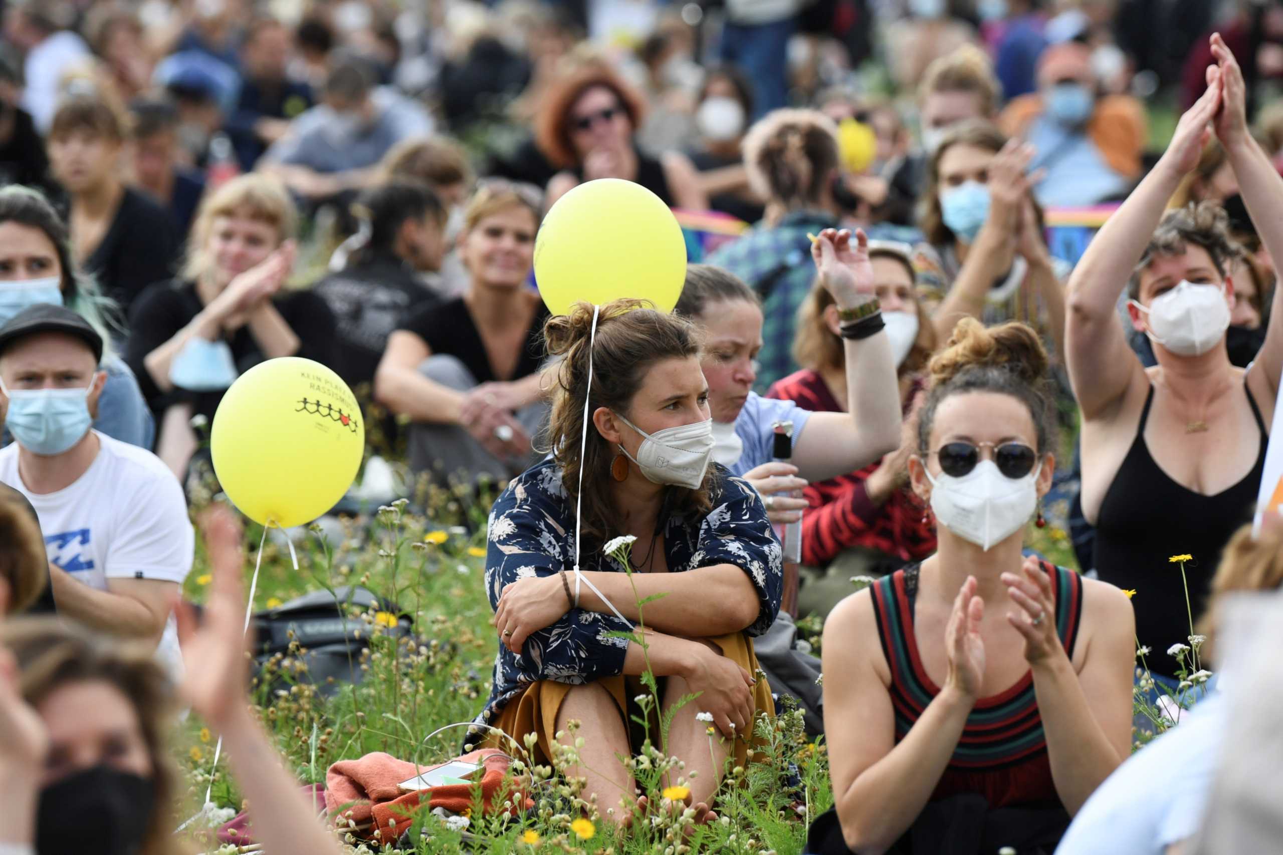 People listen to a speech as they participate in a demonstration, with the motto "For a solidarity and fair society", by the action alliance #indivisible in Berlin, Germany, September 4, 2021. REUTERS