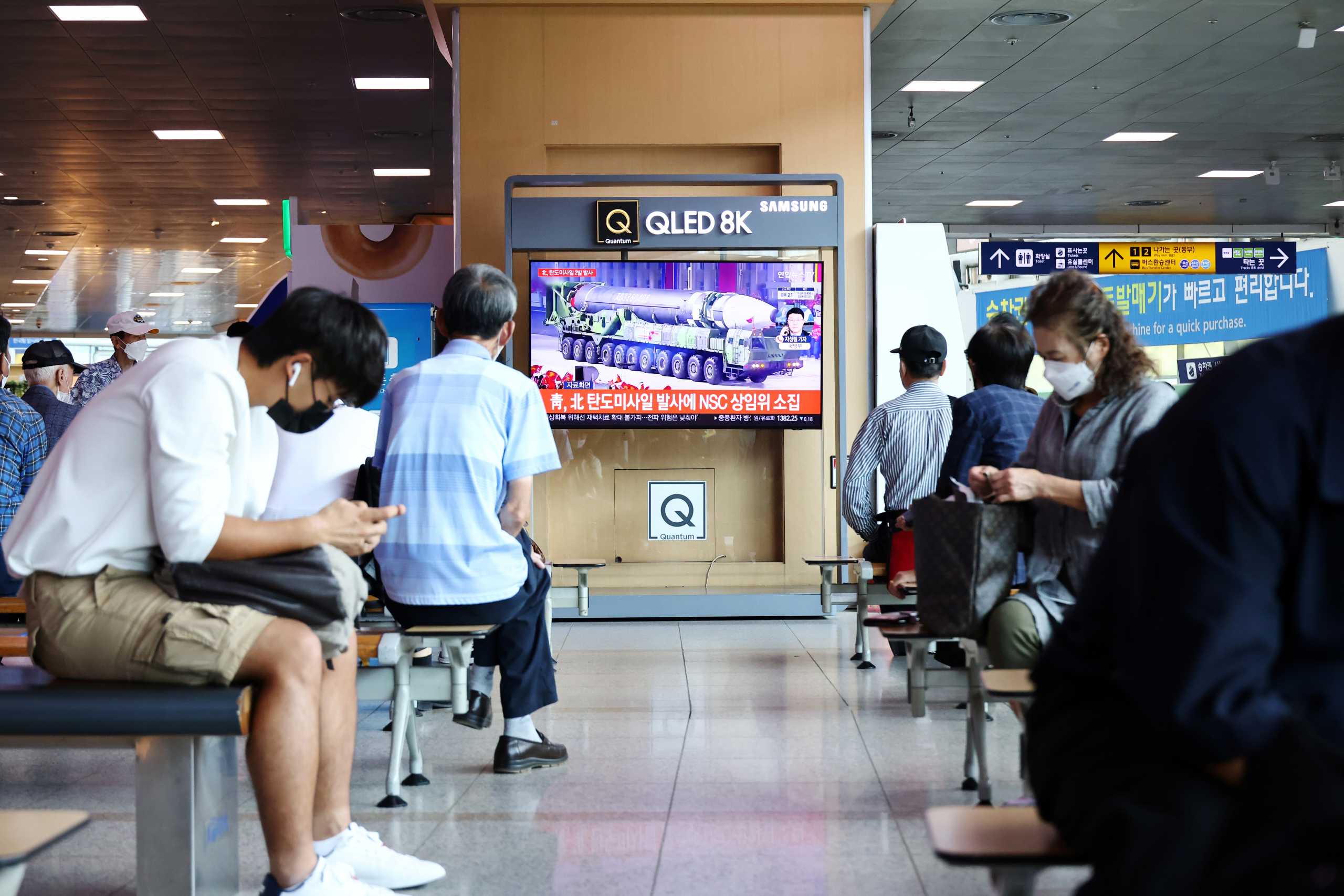 People watch a TV broadcasting file footage of a news report on North Korea firing what appeared to be a pair of ballistic missiles off its east coast, in Seoul, South Korea, September 15, 2021.    REUTERS