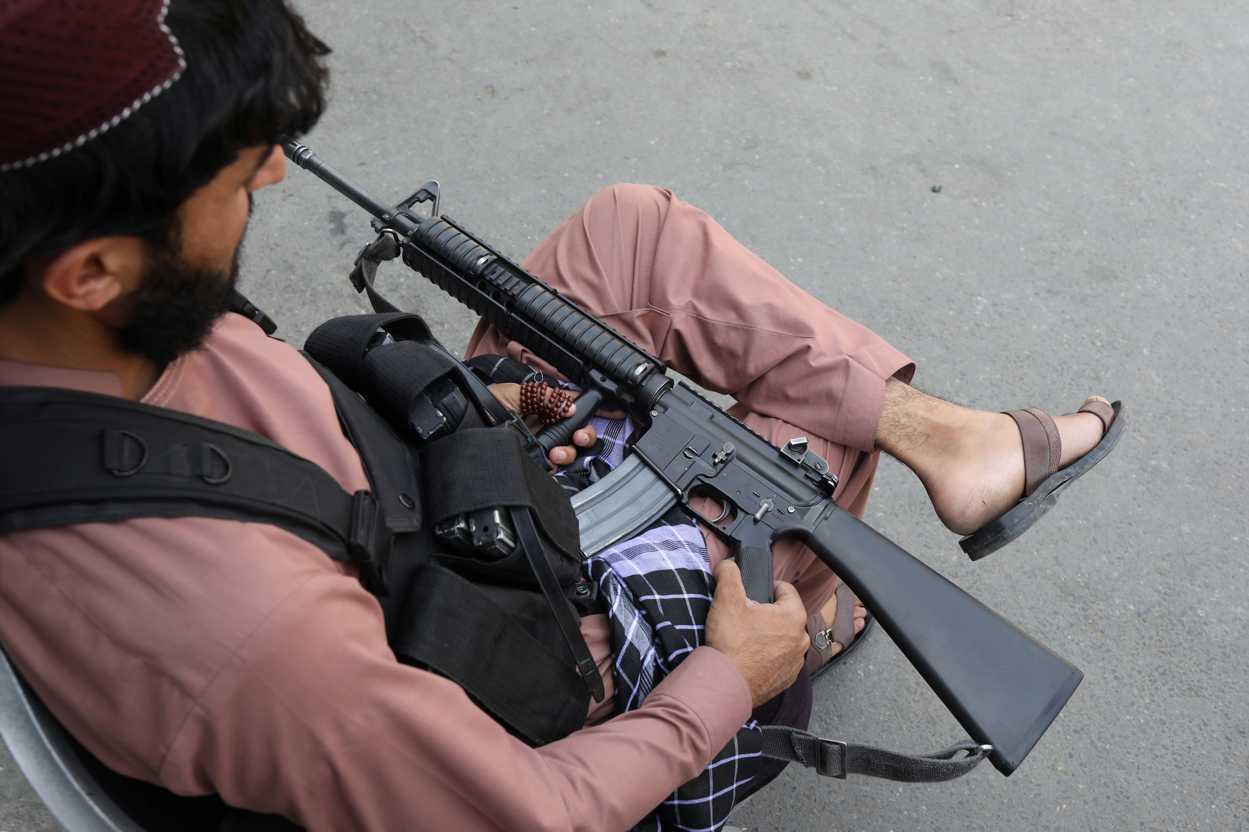 A member of the Taliban sits while holding his gun in Kabul, Afghanistan, September 4, 2021. WANA (West Asia News Agency) via REUTERS ATTENTION EDITORS - THIS IMAGE HAS BEEN SUPPLIED BY A THIRD PARTY.