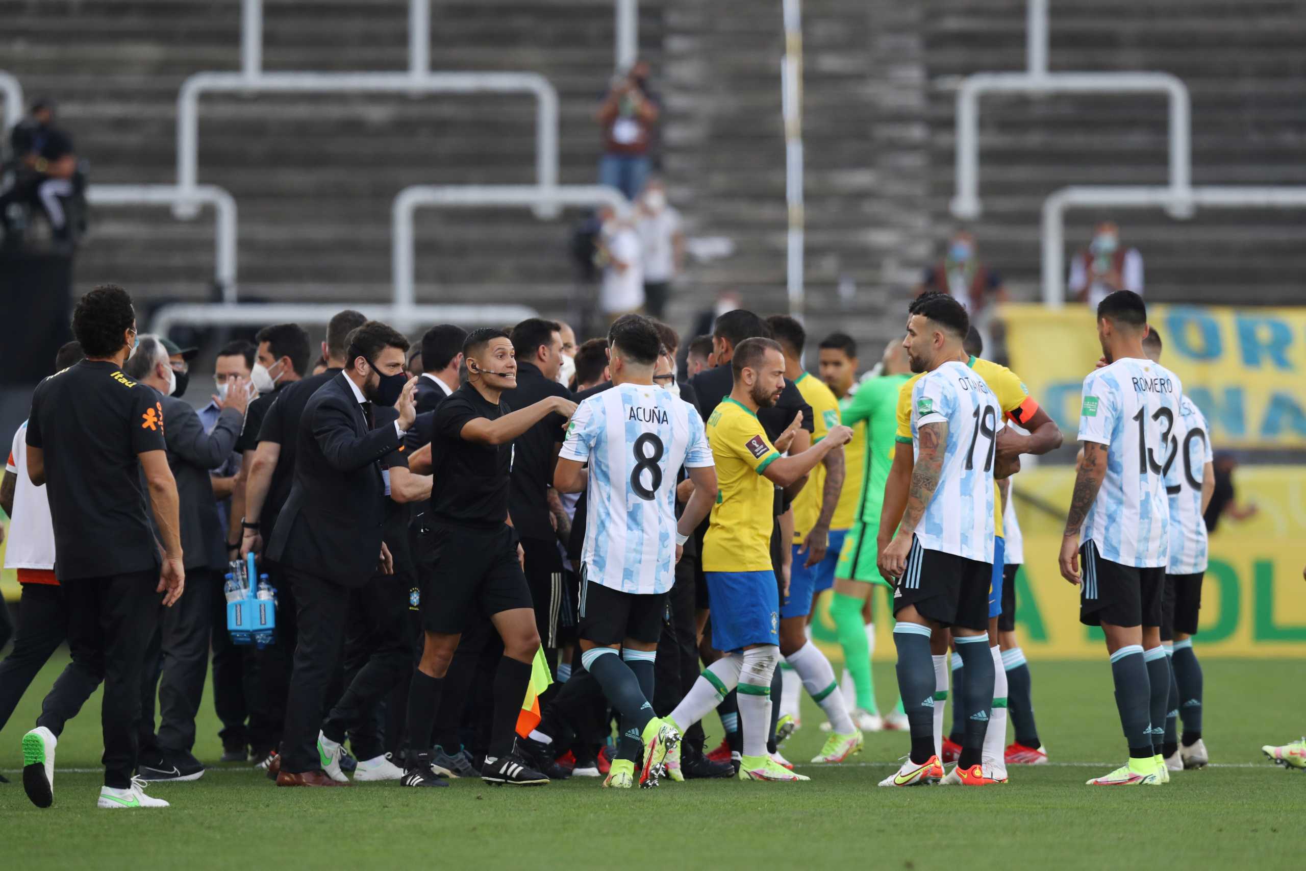 Soccer Football - World Cup - South American Qualifiers - Brazil v Argentina - Arena Corinthians, Sao Paulo, Brazil - September 5, 2021 Players and officials are seen on the pitch as play is interrupted after Brazilian health officials objected to the participation of three Argentine players they say broke quarantine rules REUTERS
