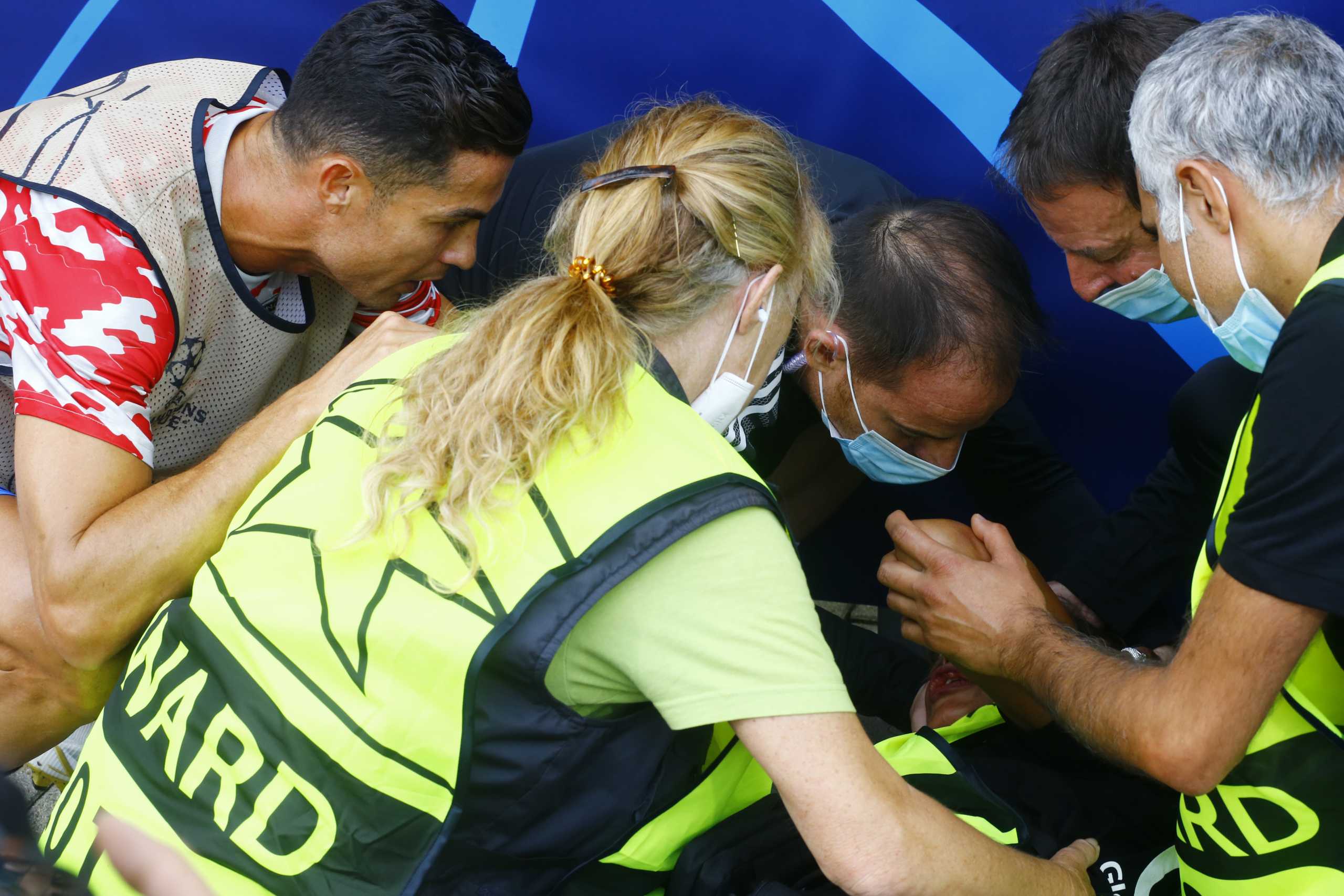 Soccer Football - Champions League - Group F - BSC Young Boys v Manchester United - Stadion Wankdorf, Bern, Switzerland- September 14, 2021 Manchester United's Cristiano Ronaldo checks on a steward after she was hit by a ball during the warm up before the match REUTERS