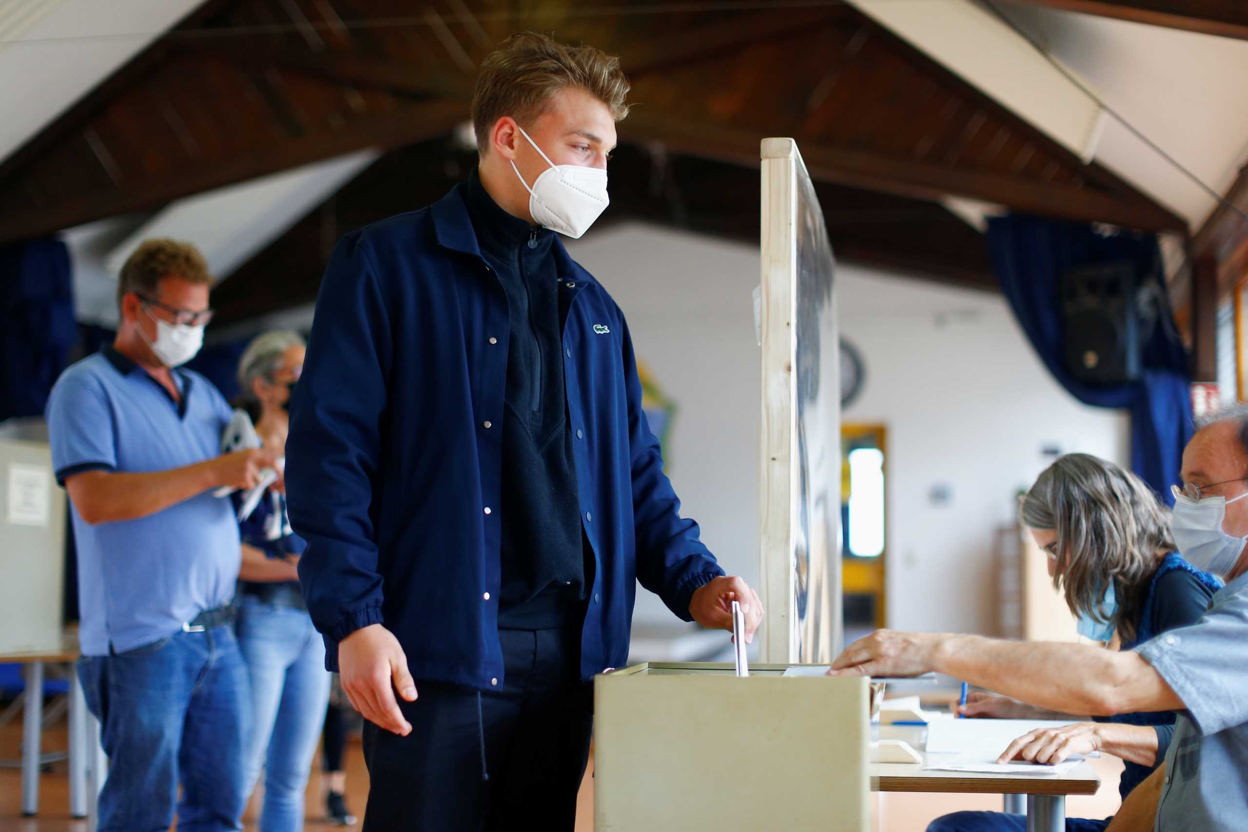A person casts their vote during the general elections, in Aachen, Germany, September 26, 2021. REUTERS
