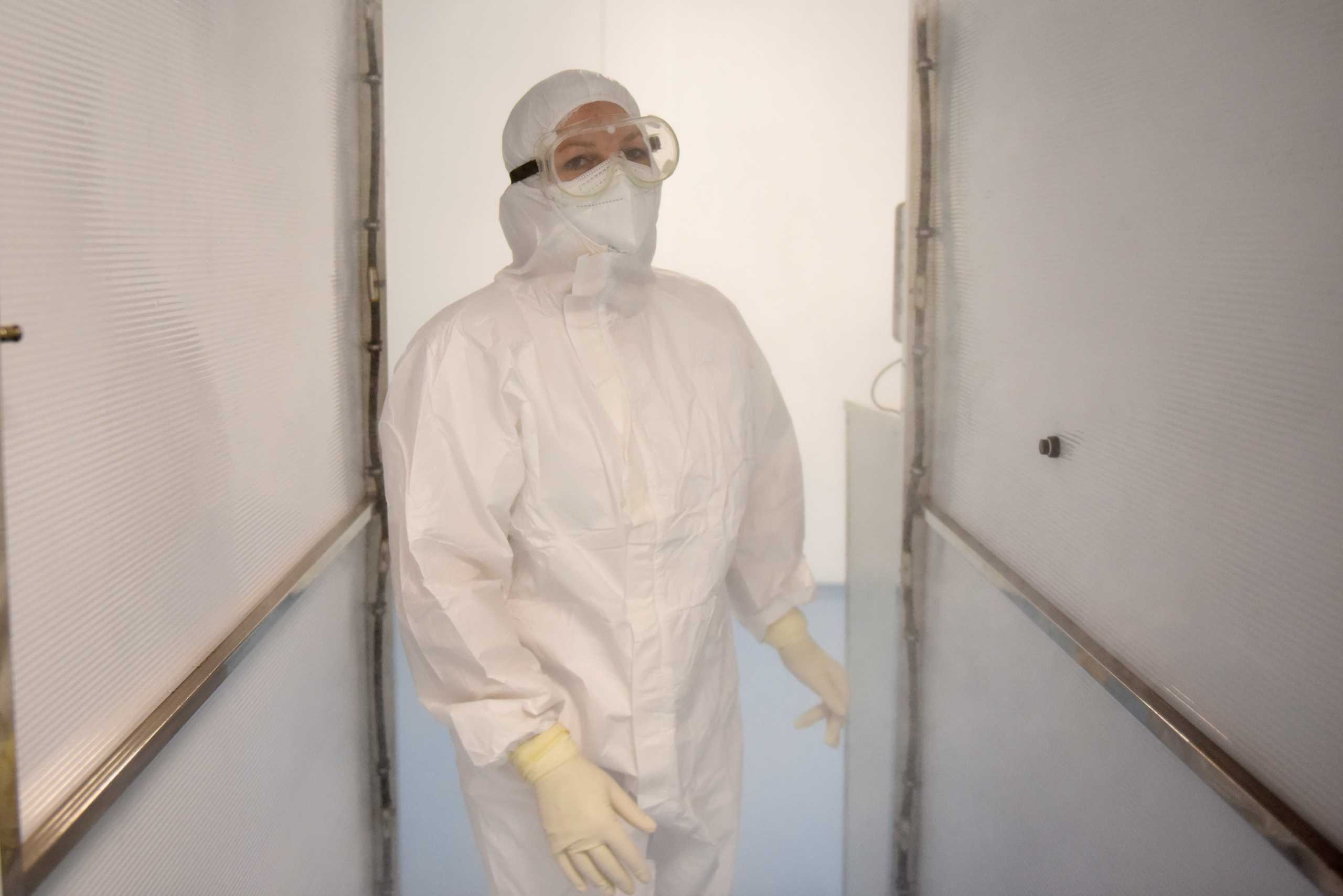 A medical worker steps into a disinfection chamber at a newly-built COVID-19 hospital in Novi Sad, Serbia, September 8, 2021.  Picture taken September 8, 2021. REUTERS