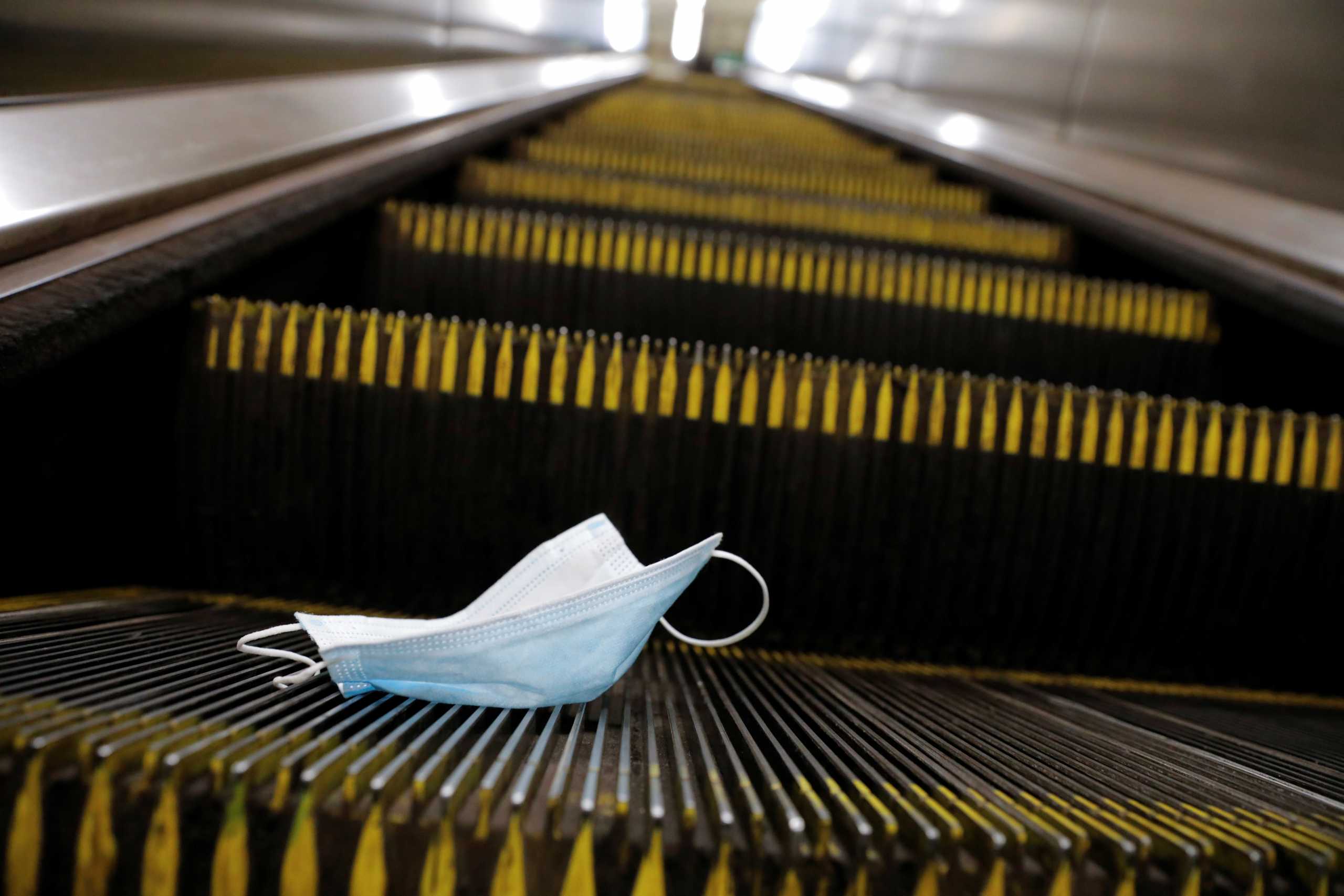 A protective mask is seen discarded on an escalator during the outbreak of the coronavirus disease (COVID-19) pandemic in Manhattan, New York City, U.S., September 3, 2021. REUTERS