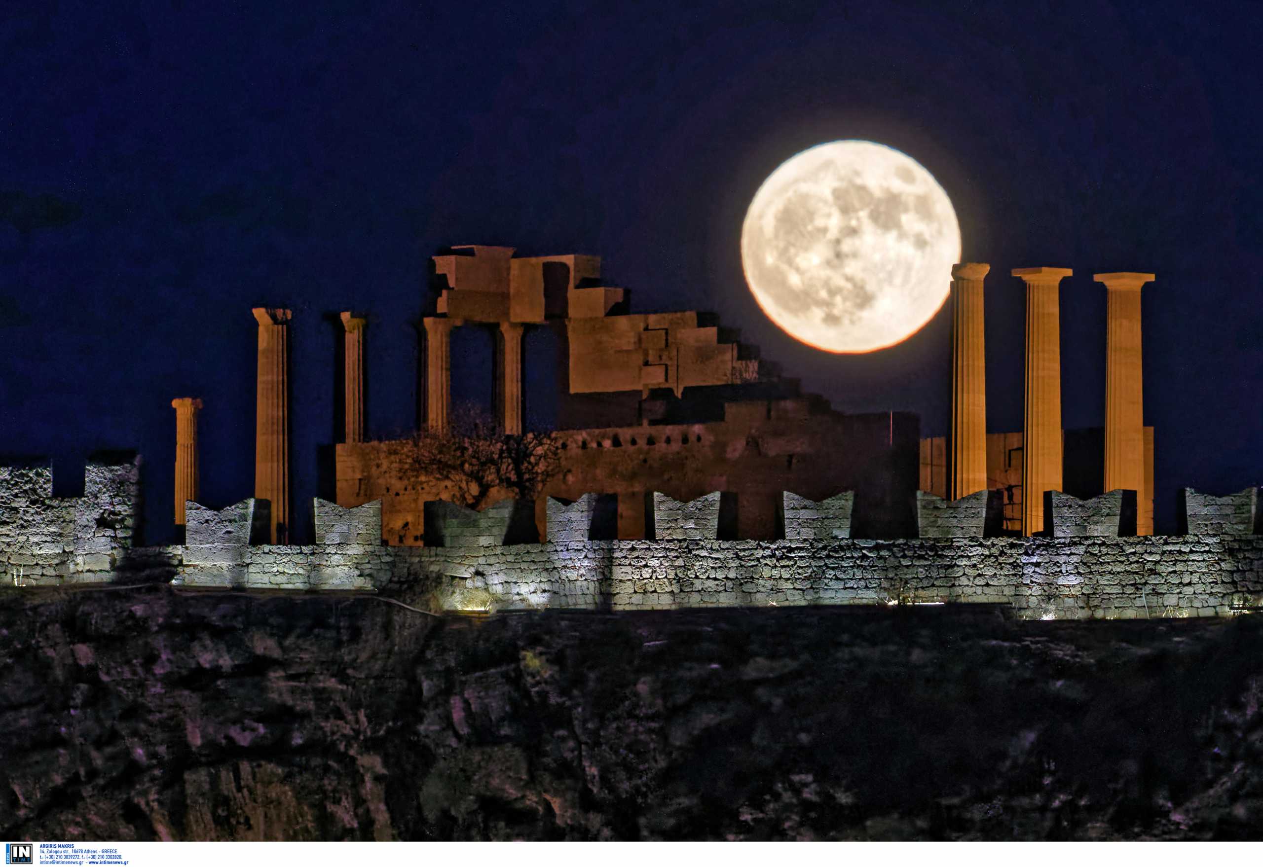 A full moon, known as a Halloween Blue Moon, is seen rising over ruins of the Acropolis of Lindos, 
a Doric temple built for Athena Lindia, the ancient goddess of wisdom, handicraft, and warfare, 
on the island of Rhodes, Greece, marking the end of the tourist season in the country which 
was affected by the Covid-19 Coronavirus pandemic. 1974 was the last time a blue moon was visible 
in the UK and Ireland and in 1944 was the last one visible across the whole world with the next one in 19 years. 
Saturday 31 October 2020