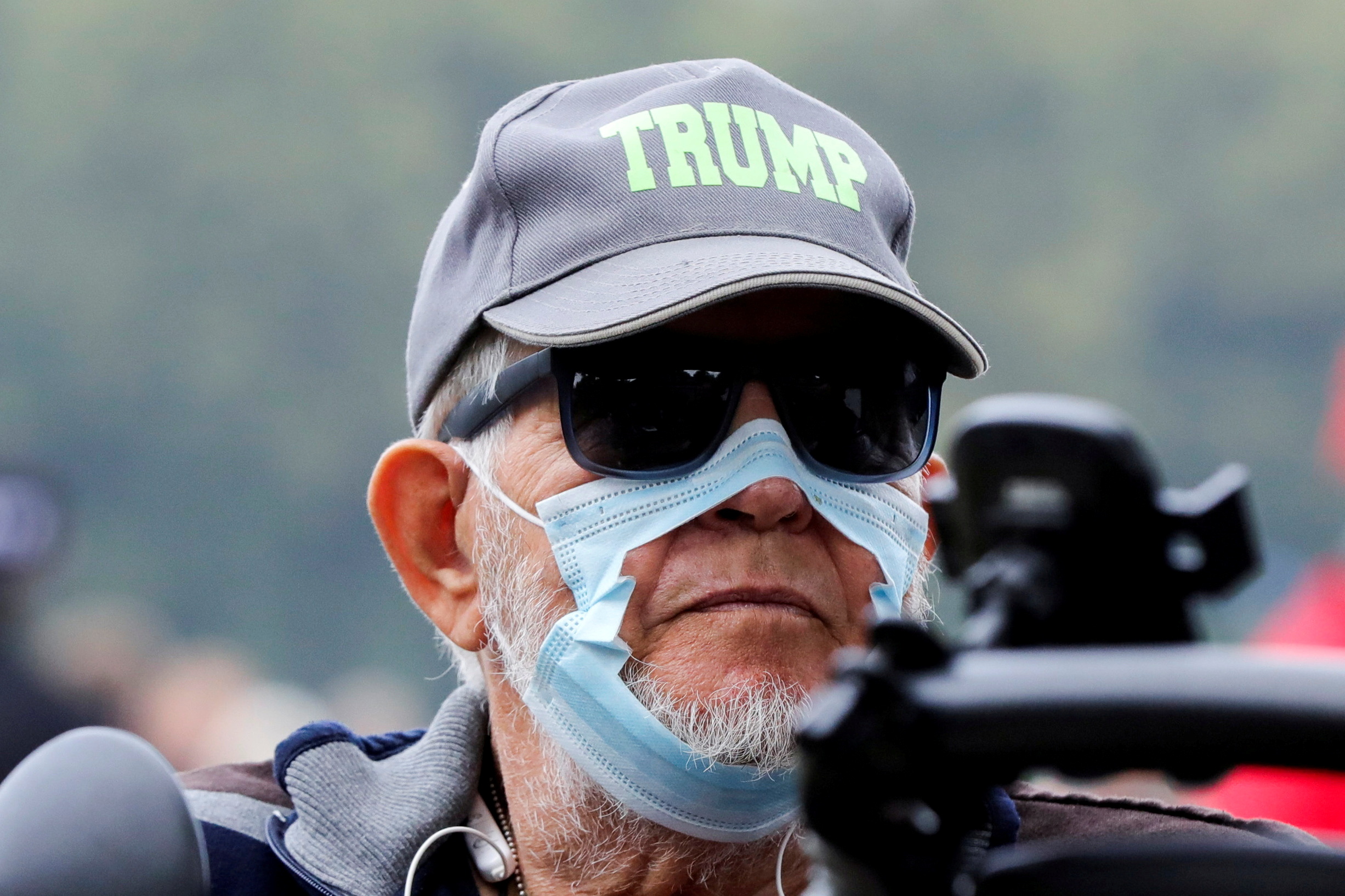 A protester wears a torn protective mask as he takes part in a protest on the day the Dutch authorities introduce a mandatory "corona pass", proof of the coronavirus disease (COVID-19) vaccination or a negative test result, to enter bars, restaurants and cultural events in the country, in The Hague, Netherlands September 25, 2021.  REUTERS