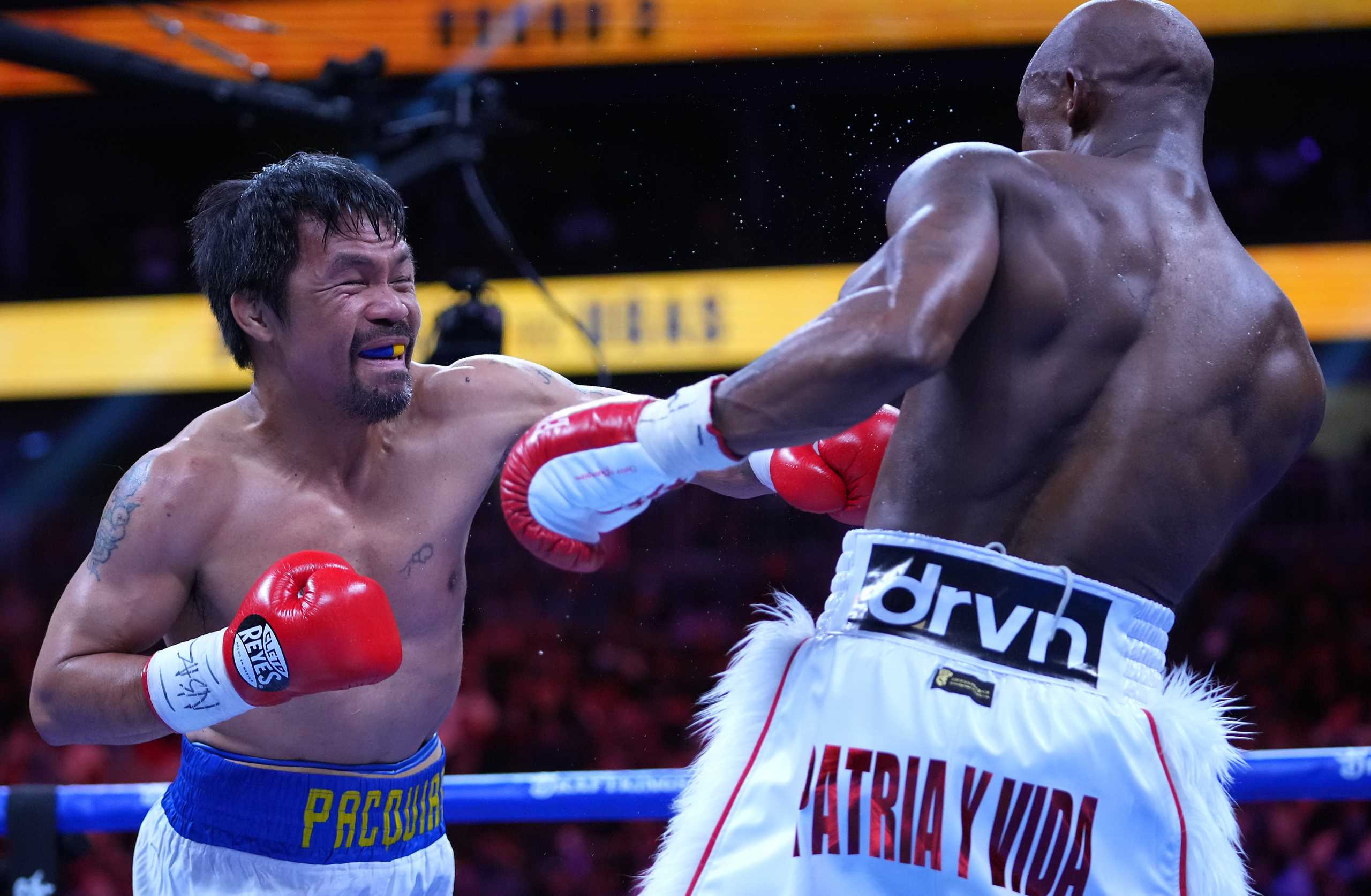 Aug 21, 2021; Las Vegas, Nevada; Manny Pacquiao fights Yordenis Ugas in a world welterweight championship bout at T-Mobile Arena. Mandatory Credit: Stephen R. Sylvanie-USA TODAY Sports