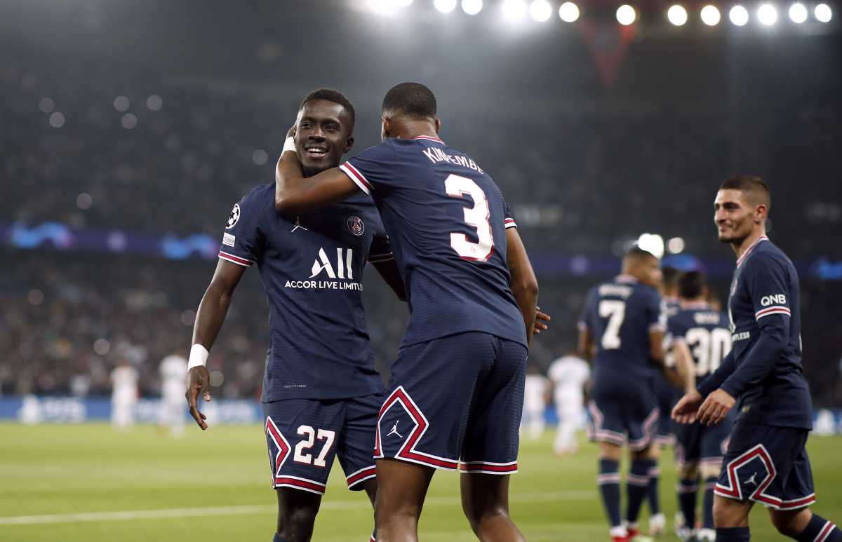 Soccer Football - Champions League - Group A - Paris St Germain v Manchester City - Parc des Princes, Paris, France - September 28, 2021 Paris St Germain's Idrissa Gueye celebrates scoring their first goal with Presnel Kimpembe REUTERS