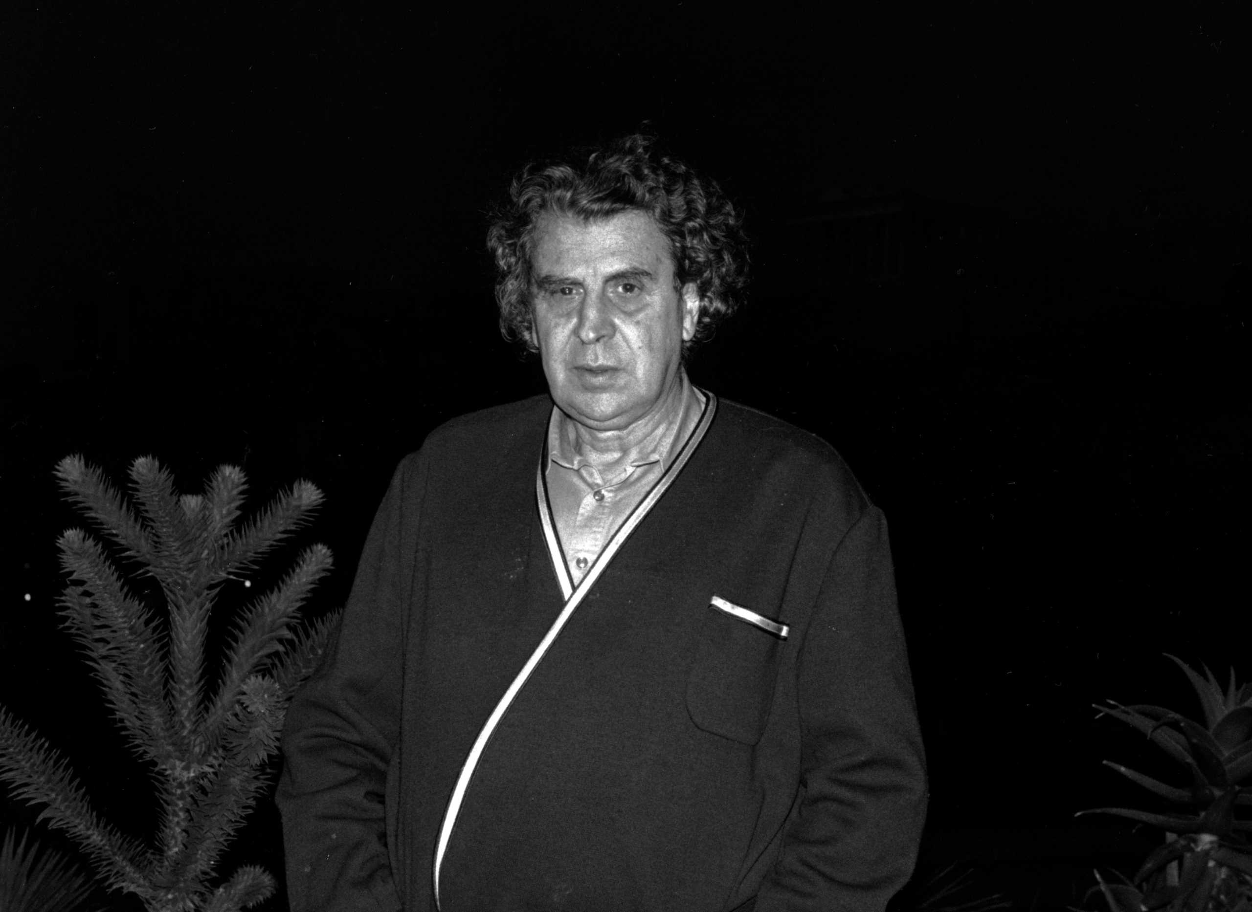 FILE PHOTO: Composer of the "Zorba the Greek", Mikis Theodorakis, gives an interview to Reuters on his balcony across from the Acropolis in Athens October 18, 1989. Theodorakis has switched his allegiance from communists to Conservatives. REUTERS
