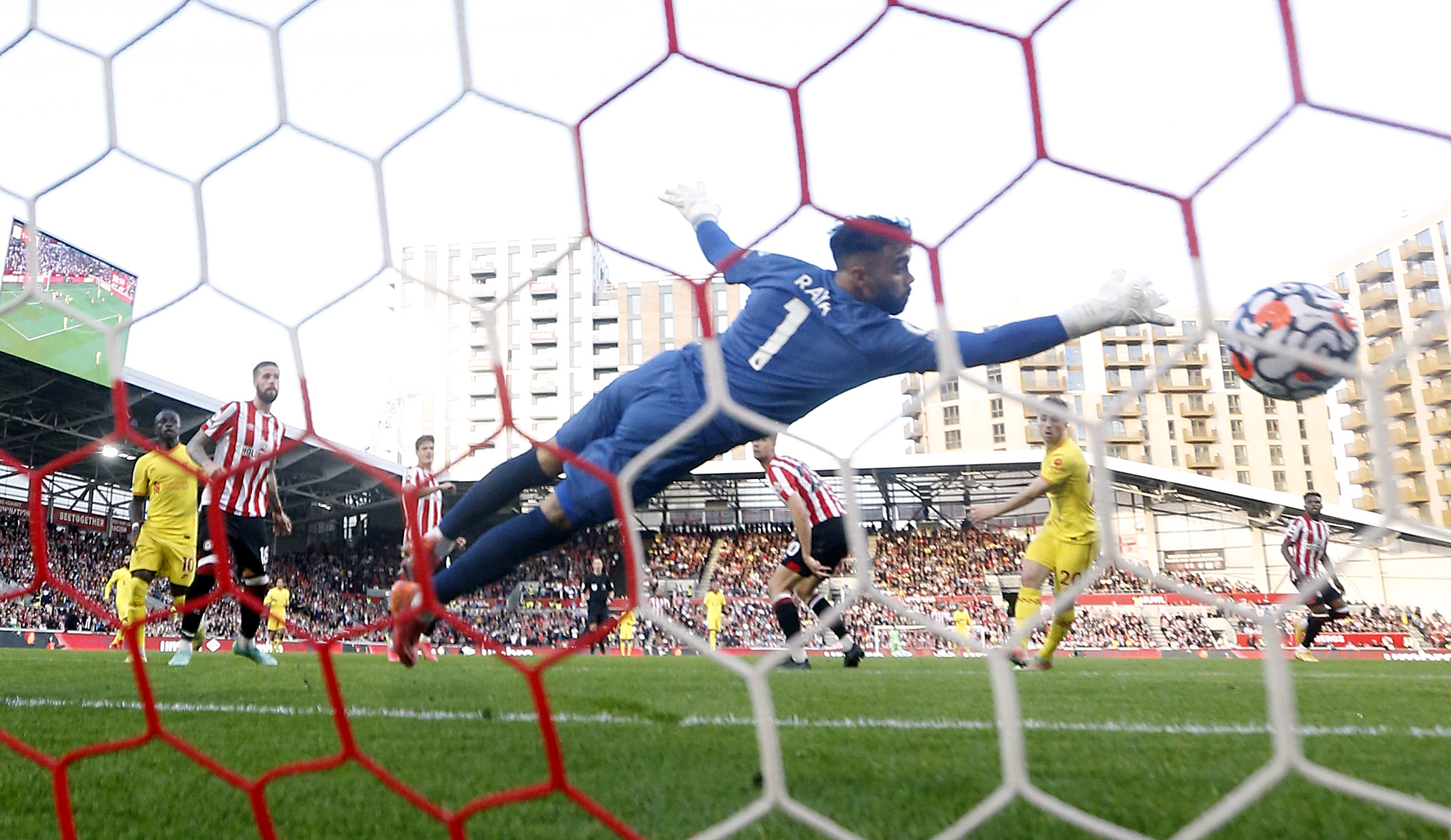 Soccer Football - Premier League - Brentford v Liverpool - Brentford Community Stadium, London, Britain - September 25, 2021  Liverpool's Diogo Jota scores their first goal past Brentford's David Raya Action Images via Reuters
