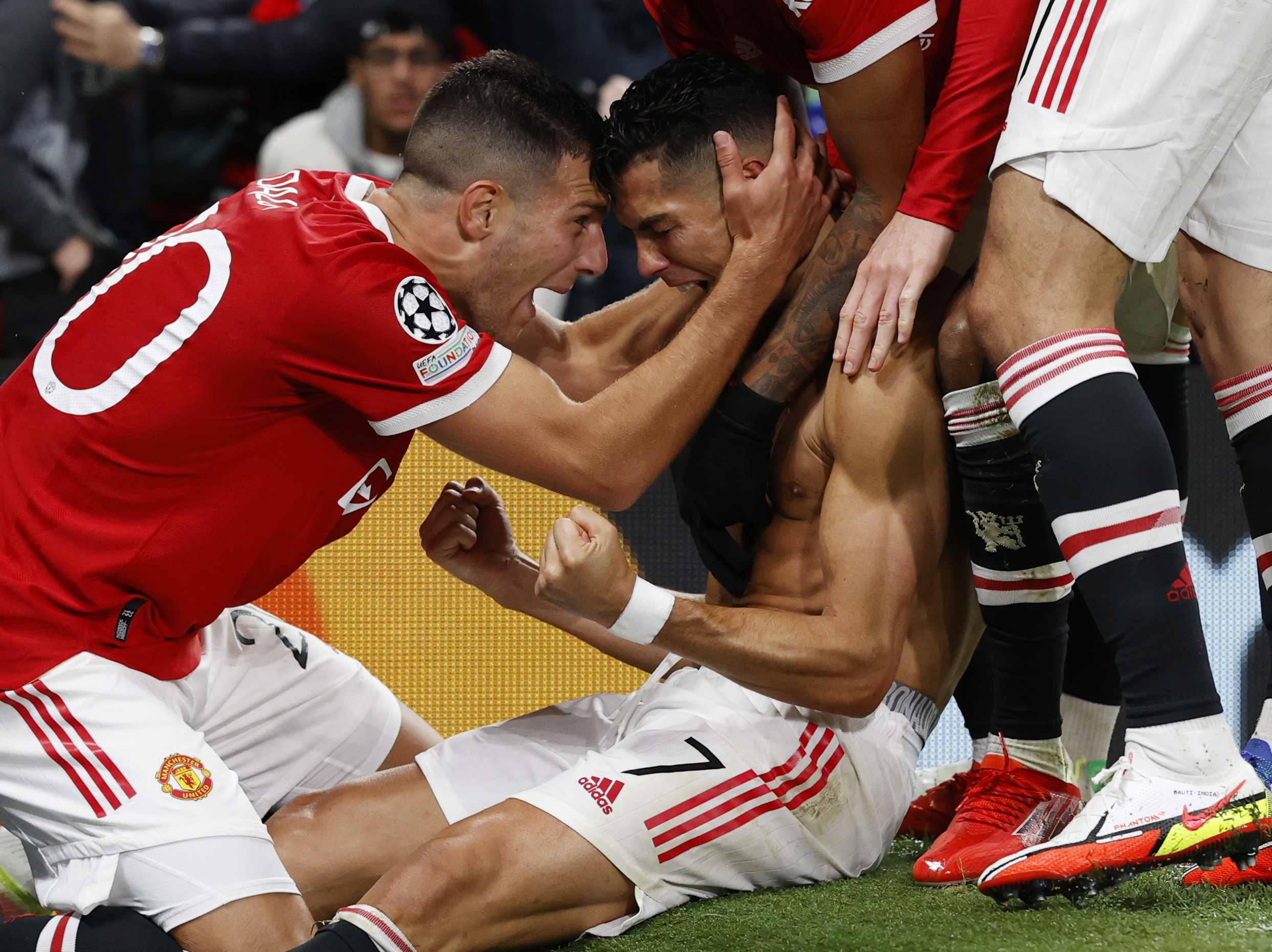 Soccer Football - Champions League - Group F - Manchester United v Villarreal - Old Trafford, Manchester, Britain - September 29, 2021 Manchester United's Cristiano Ronaldo celebrates scoring their second goal with Diogo Dalot REUTERS