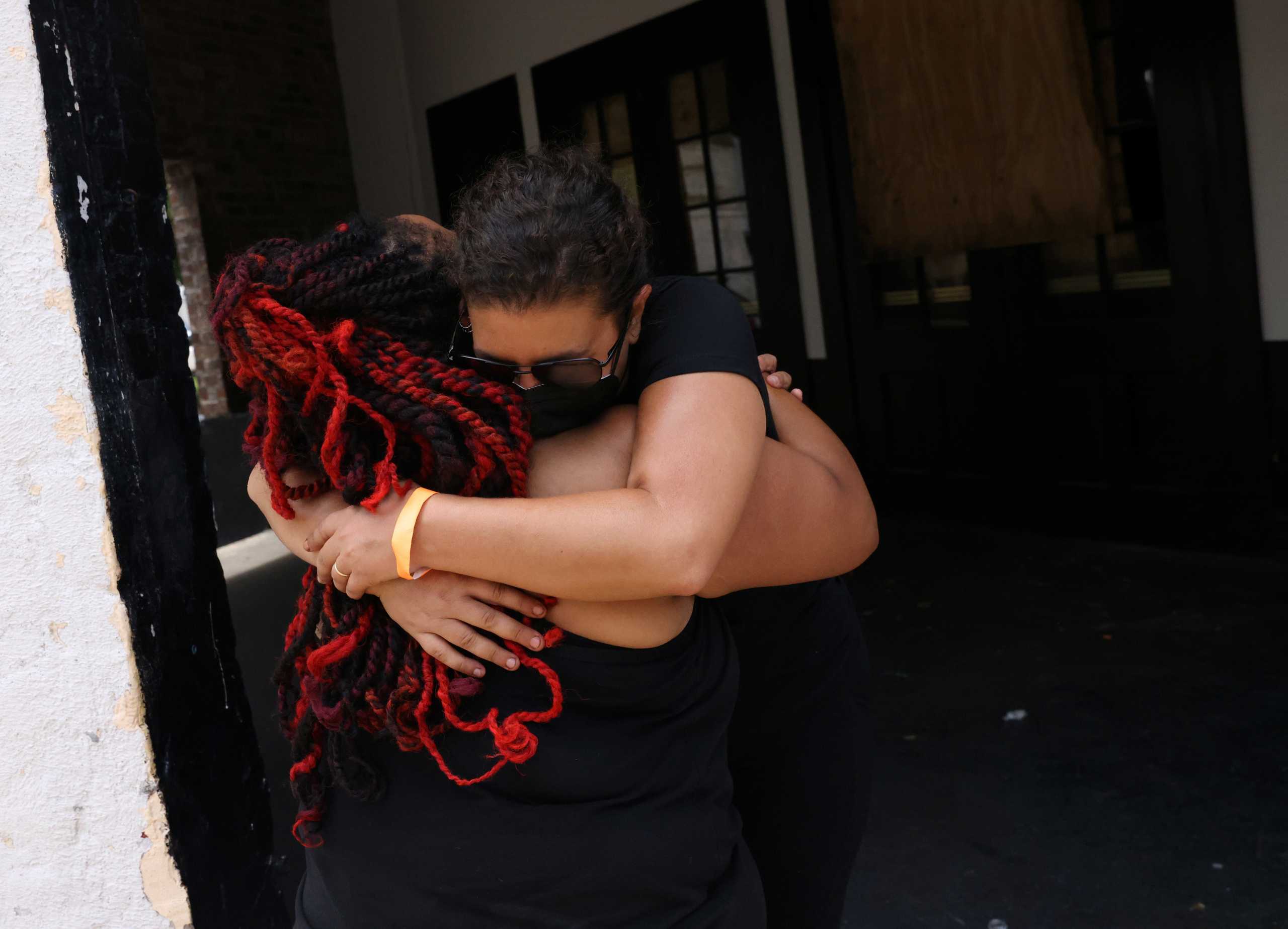 Arsene DeLay hugs Erica Chomsky-Adelson, Executive Director, Culture aid Nola after DeLay spent the morning delivering goods to musicians, through New Orleans Musicians' Clinic, as large parts of the city of New Orleans continue to be mostly without power days after hurricane Ida tore through the state in Louisiana, U.S., September 4, 2021. REUTERS