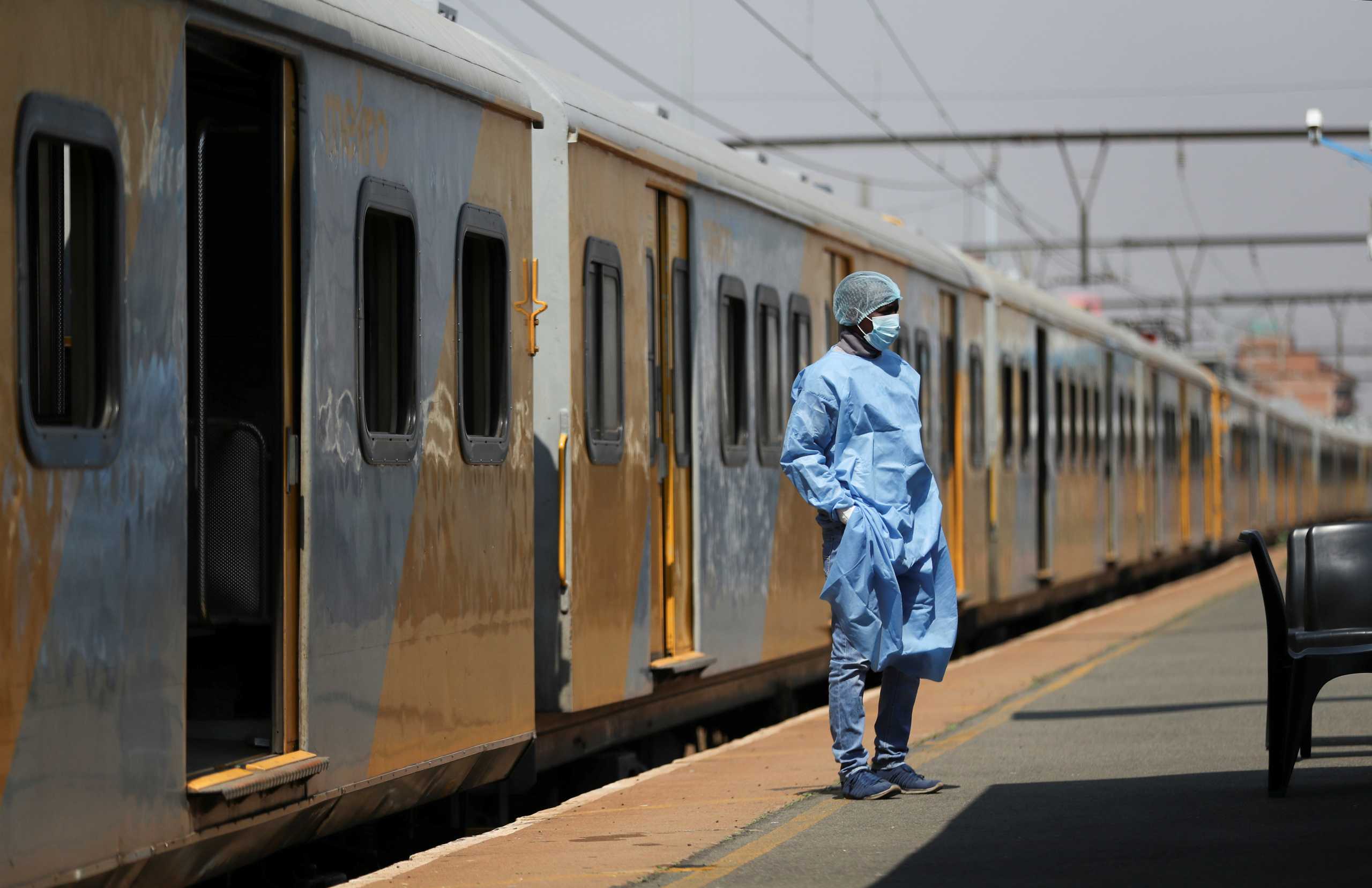 A health worker takes a break, as South Africa's rail company Transnet turned a train (not in the picture) into a coronavirus disease (COVID-19) vaccination center on rails to help the government speed up its vaccine rollout in the country's remote communities, at the Springs train station on the East Rand, South Africa, August 27, 2021. Picture taken August 27, 2021. REUTERS