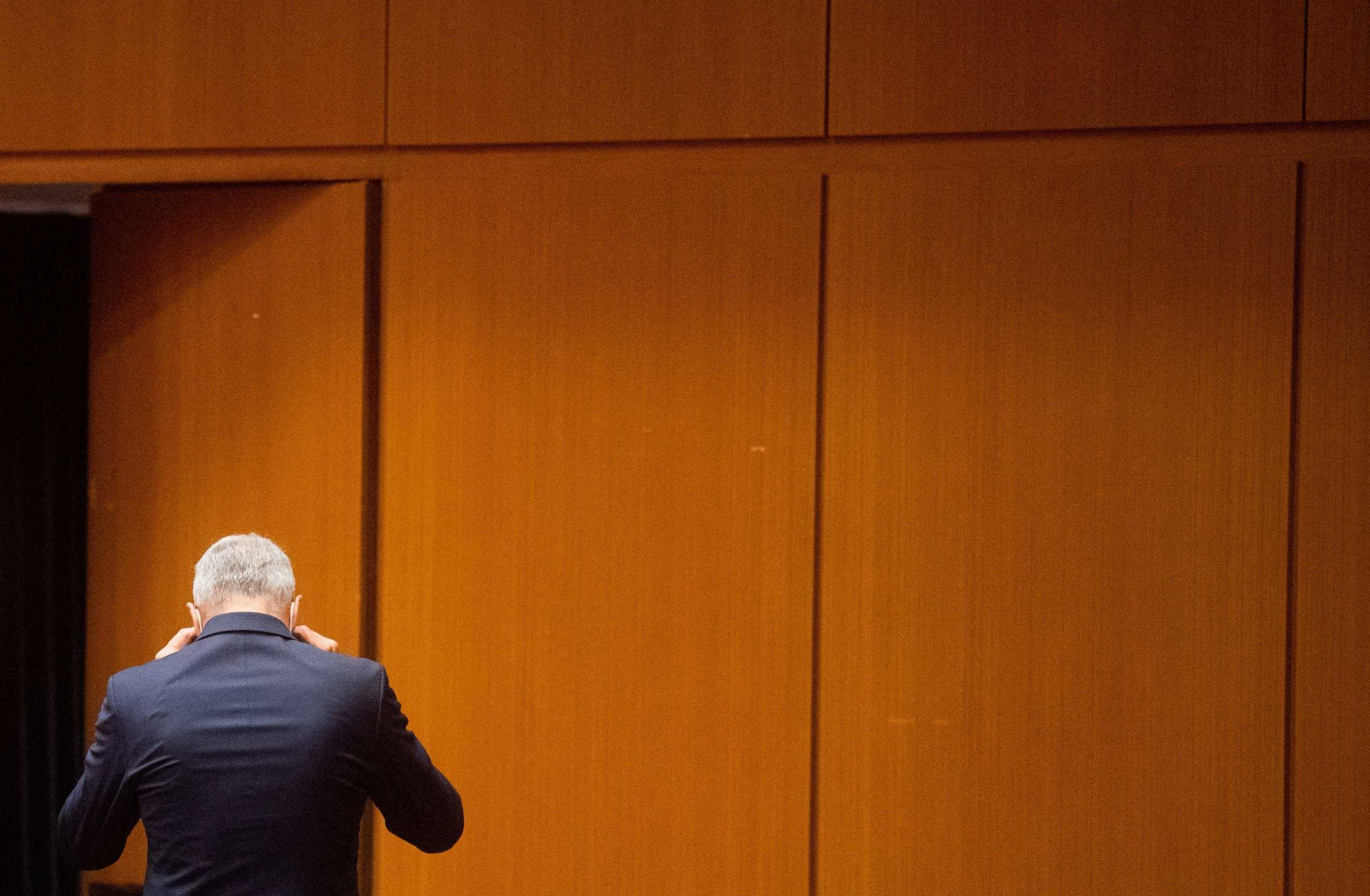 A former Volkswagen executive walks at the start of his trial, charged with misconduct over their role in the carmaker's manipulation of diesel emissions testing, in Brunswick, Germany September 16, 2021.  Julian Stratenschulte