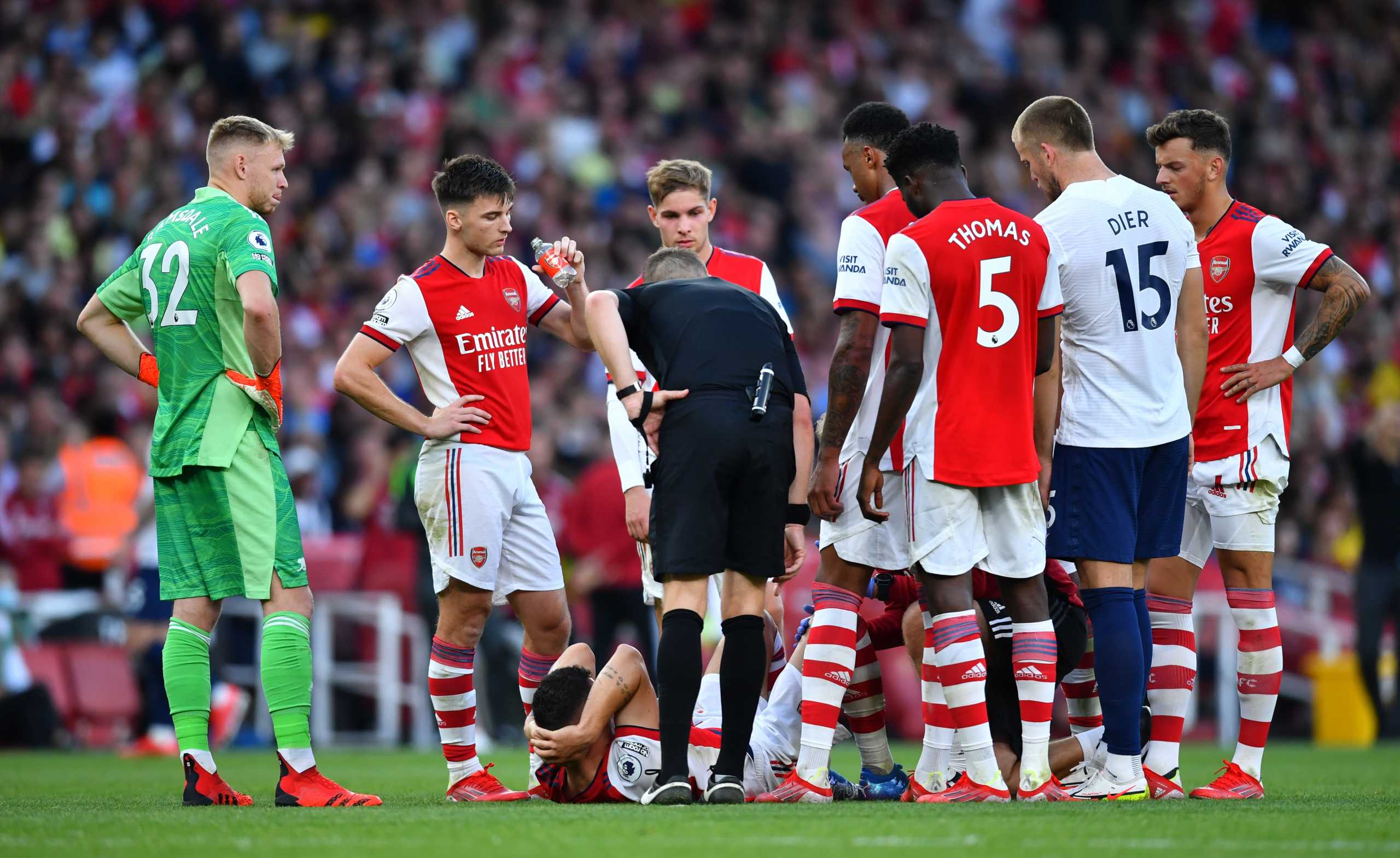 Soccer Football - Premier League - Arsenal v Tottenham Hotspur - Emirates Stadium, London, Britain - September 26, 2021  Arsenal's Granit Xhaka receives medical attention after sustaining an injury as referee Craig Pawson and players look on REUTERS
