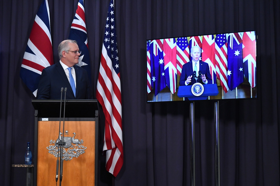 epa09470856 Australian Prime Minister Scott Morrison attends a joint press conference via audio visual link (AVL) with Britain's Prime Minister Boris Johnson (unseen) and US President Joe Biden (on screen) from The Blue Room at Parliament House in Canberra, Australian Capital Territory, Australia, 16 September 2021. Australia, the United Kingdom and the United States agreed to the creation of a trilateral security partnership to be known as AUKUS.  EPA