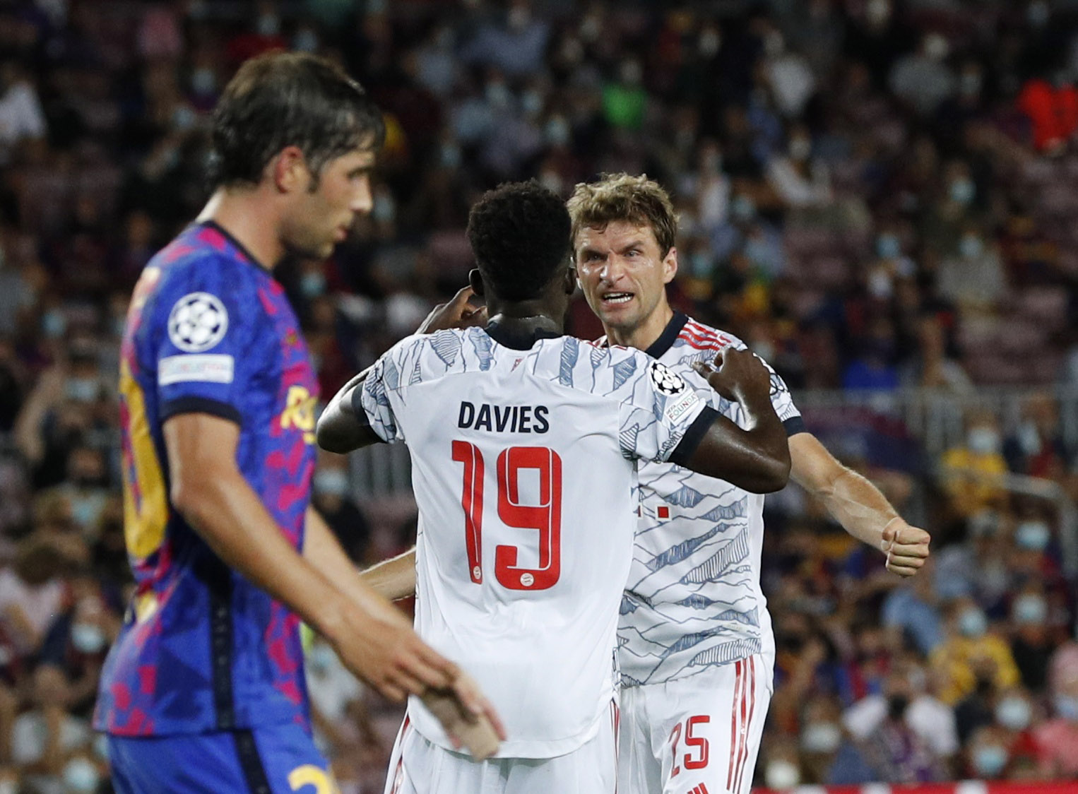 Soccer Football - Champions League - Group E - FC Barcelona vs Bayern Munich - Camp Nou, Barcelona, Spain - September 14, 2021 Bayern Munich's Thomas Muller celebrates scoring their first goal with Alphonso Davies REUTERS