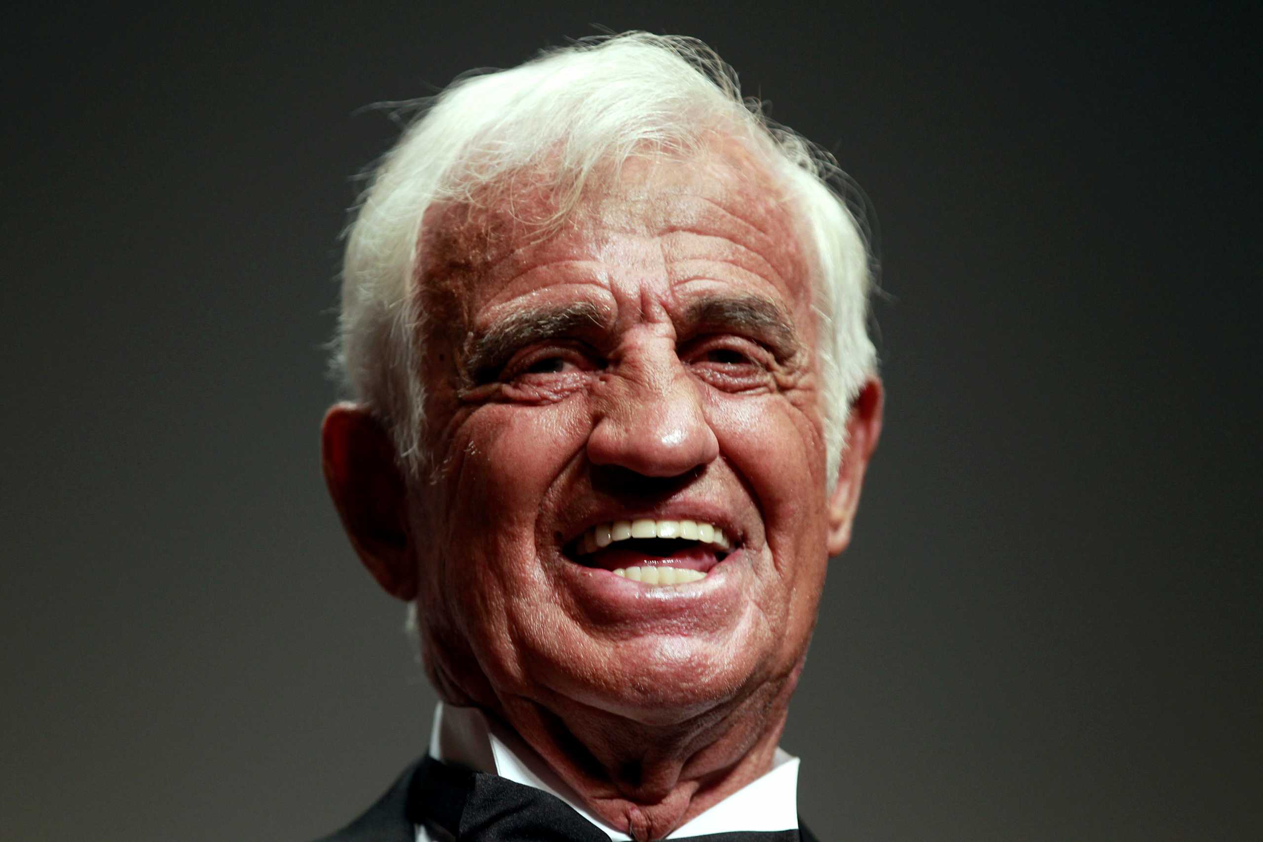 FILE PHOTO: Actor Jean-Paul Belmondo smiles after he received a Palme award prior to the screening of a documentary on his career at the 64th Cannes Film Festival, May 17, 2011.  REUTERS