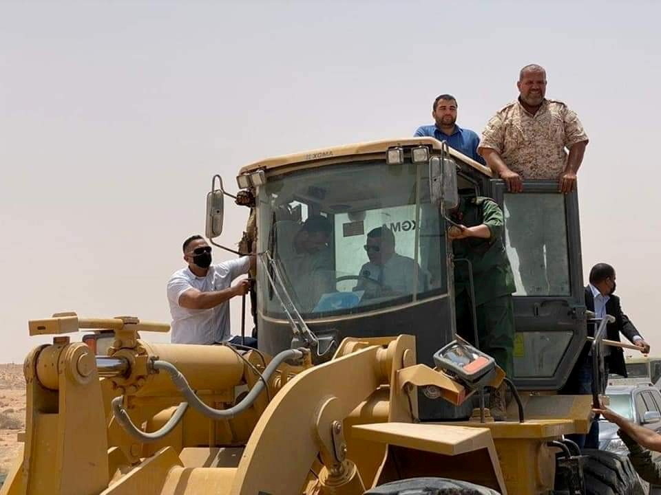 FILE PHOTO: Libyan Prime Minister Abdulhamid Dbeibeh drives a bulldozer during the re-opening of the road across the frozen frontline between east and west in Libya, June 20, 2021. REUTERS
