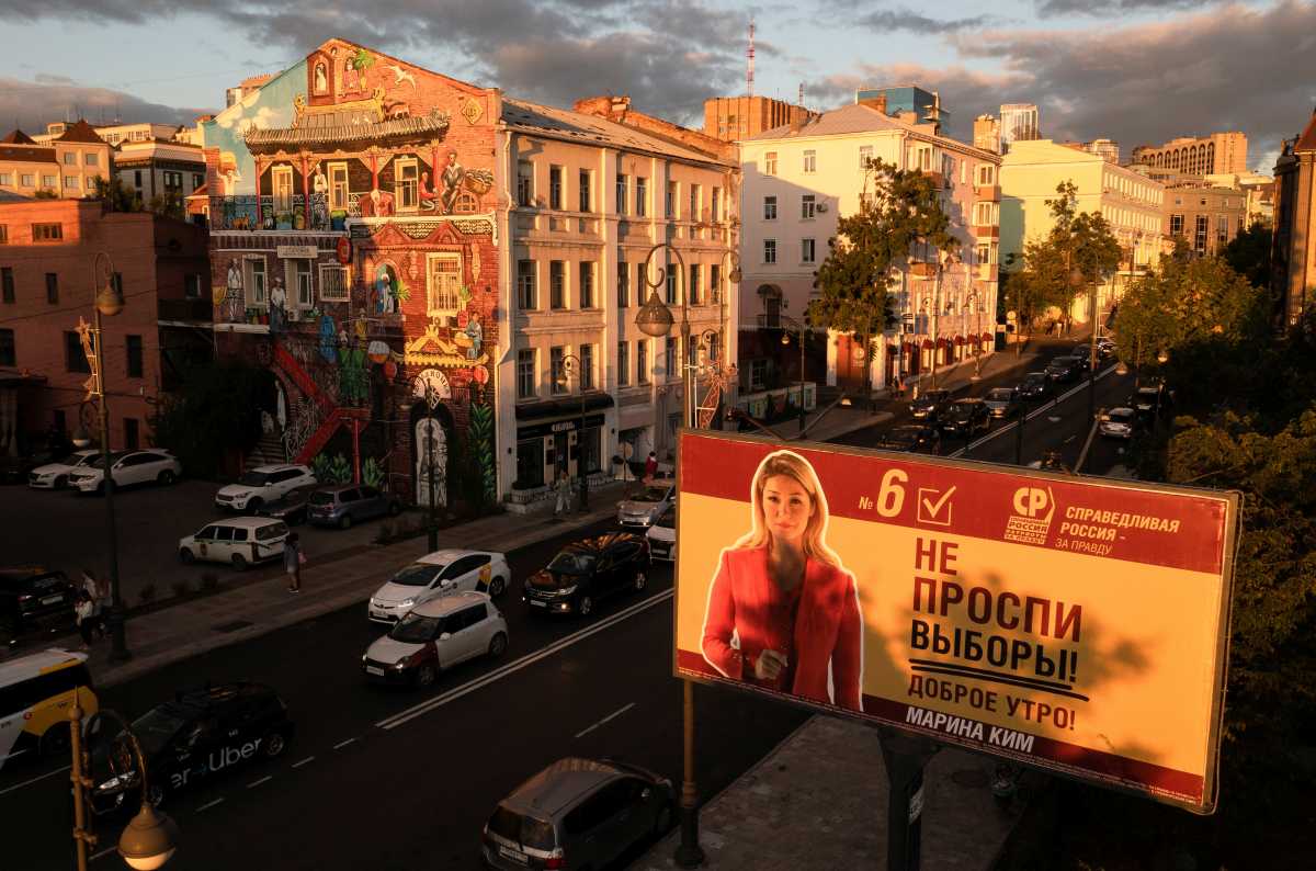 A campaign poster of Spravedlivaya Rossiya - Za pravdu (A Just Russia - For Truth) party candidate for parliamentary election is seen at sunset in Vladivostok, Russia September 12, 2021. Picture taken with a drone.   REUTERS