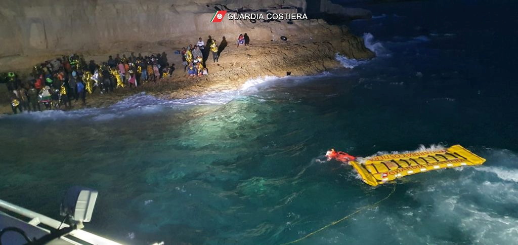 Italian coastguard members rescue 125 migrants who were found stranded on the shores of Isola dei Conigli, a small island close to Lampedusa, Italy, September 9, 2021. Italian Coast Guard