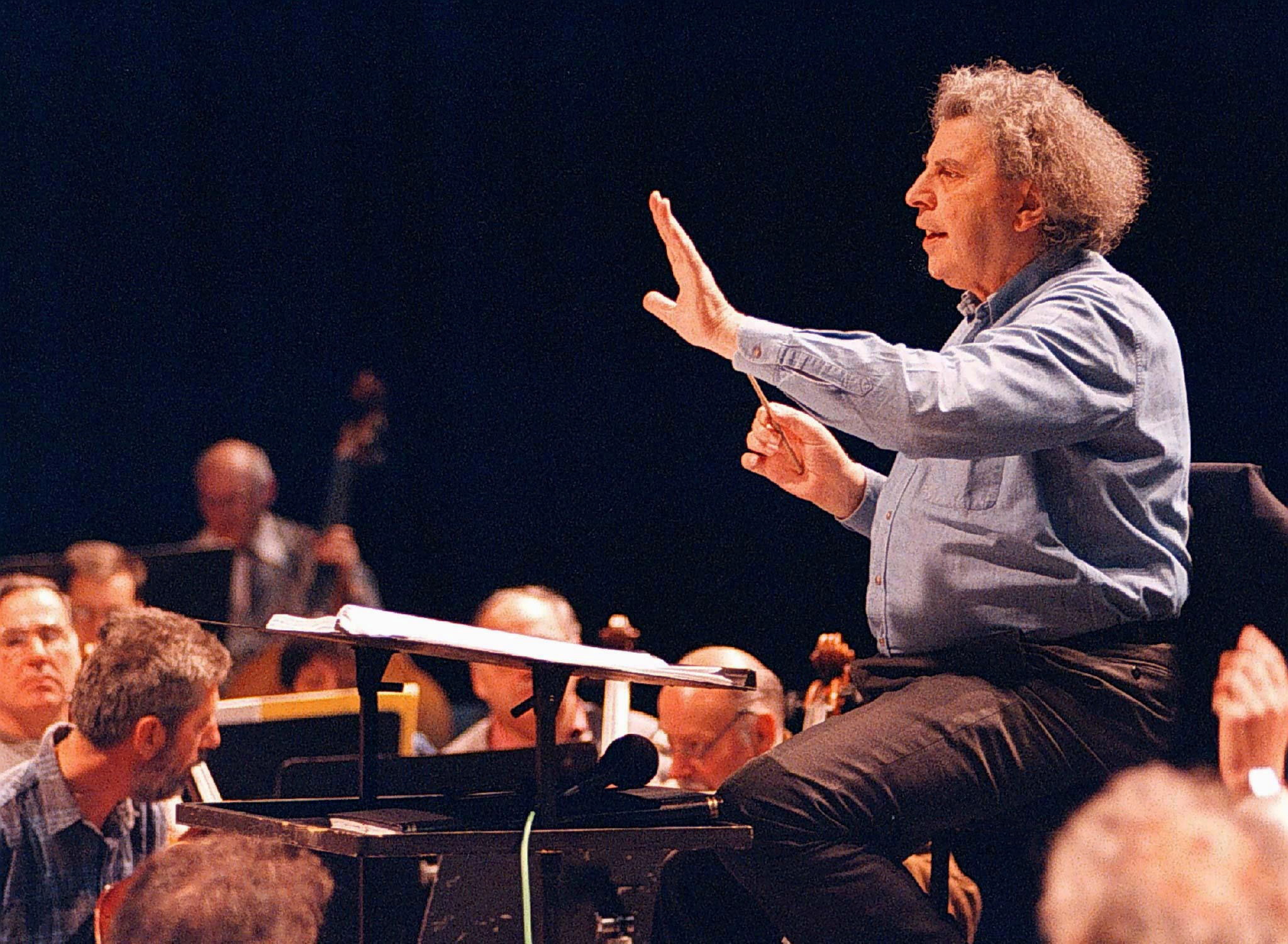 FILE PHOTO: Greek composer Mikis Theodorakis conducts the Skopje's opera orchestra during a rehearsal in the Macedonian capital, April 9, 1997. Stringer