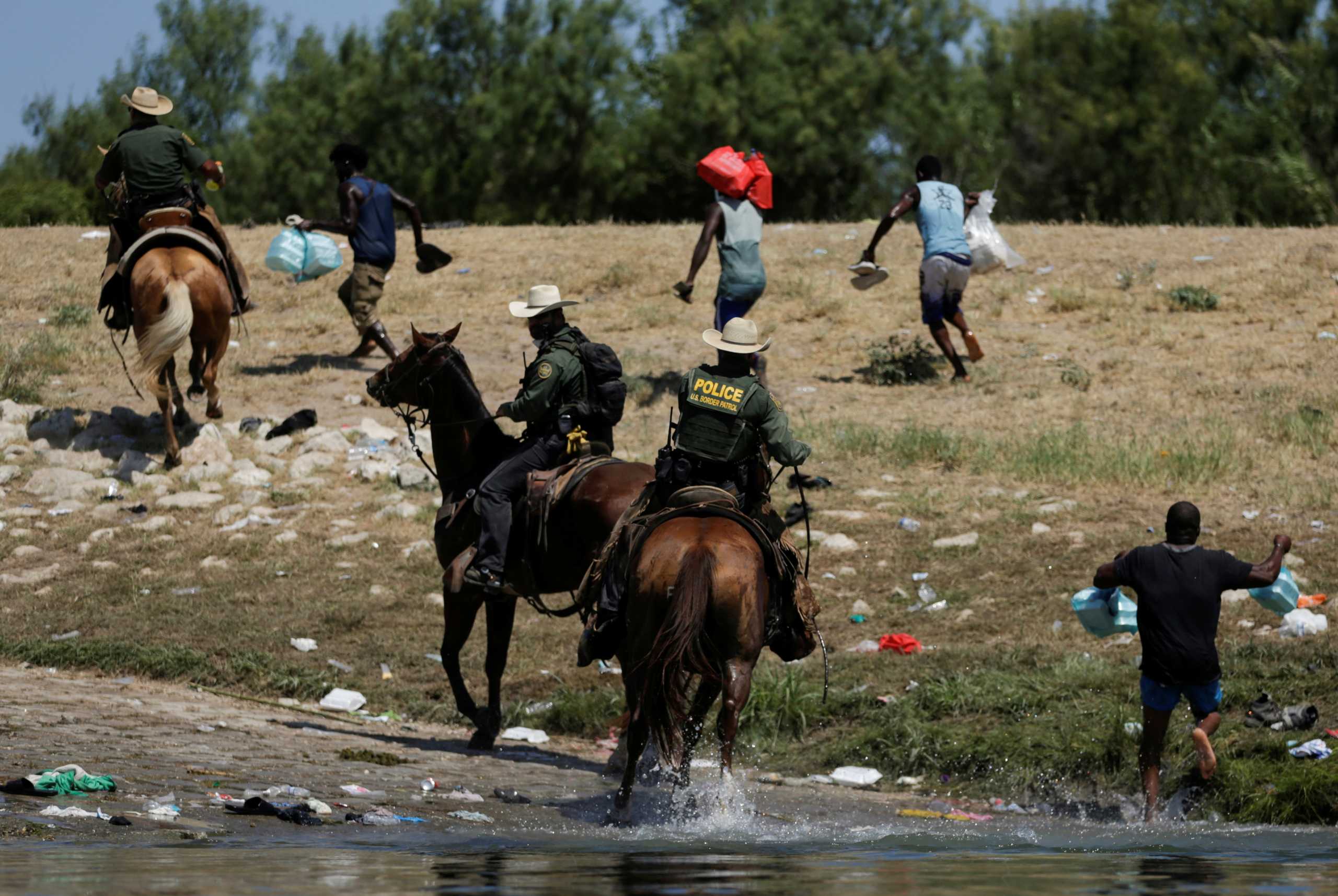 U.S. border patrol officers chase migrants asylum seekers as they are trying to return to the United States along the Rio Grande river, after having crossed from the United States into Mexico to buy food, as seen from Ciudad Acuna, in Ciudad Acuna, Mexico September 19, 2021. REUTERS