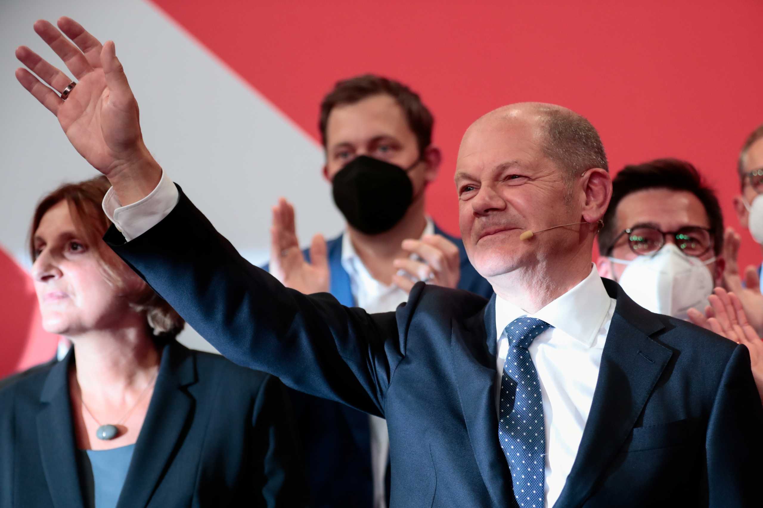 Social Democratic Party (SPD) leader and top candidate for chancellor Olaf Scholz waves after first exit polls for the general elections in Berlin, Germany, September 26, 2021.    REUTERS