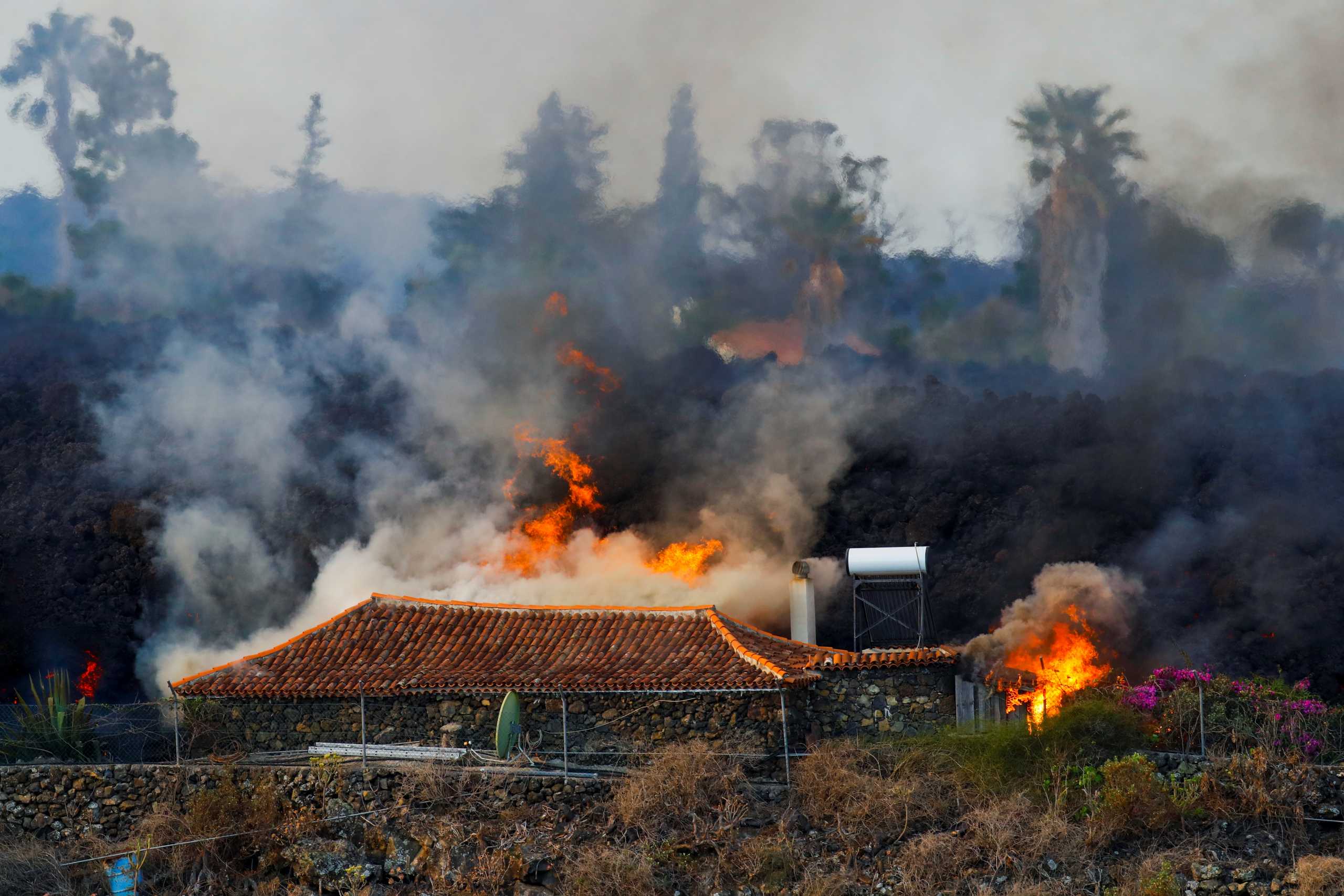 A house burns due to lava from the eruption of a volcano in the Cumbre Vieja national park, in the residential area of Los Campitos at Los Llanos de Aridane, on the Canary Island of La Palma, September 20, 2021. REUTERS
