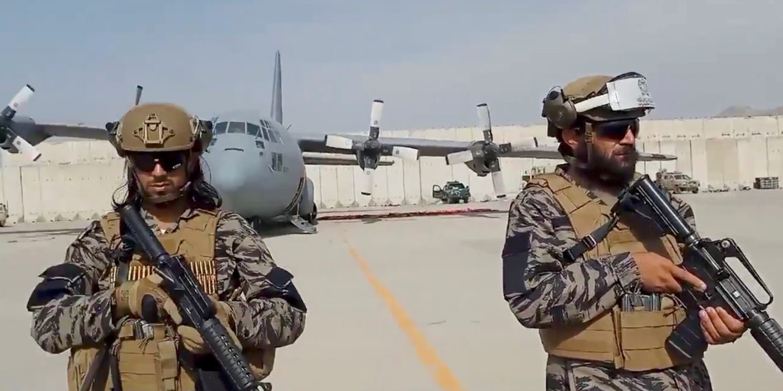 Members of Badri 313 military unit stand guard as Taliban spokesman Zabihullah Mujahid delivers his remarks at Kabul's airport, Afghanistan August 31, 2021 in this still image obtained from a handout video.  Taliban
