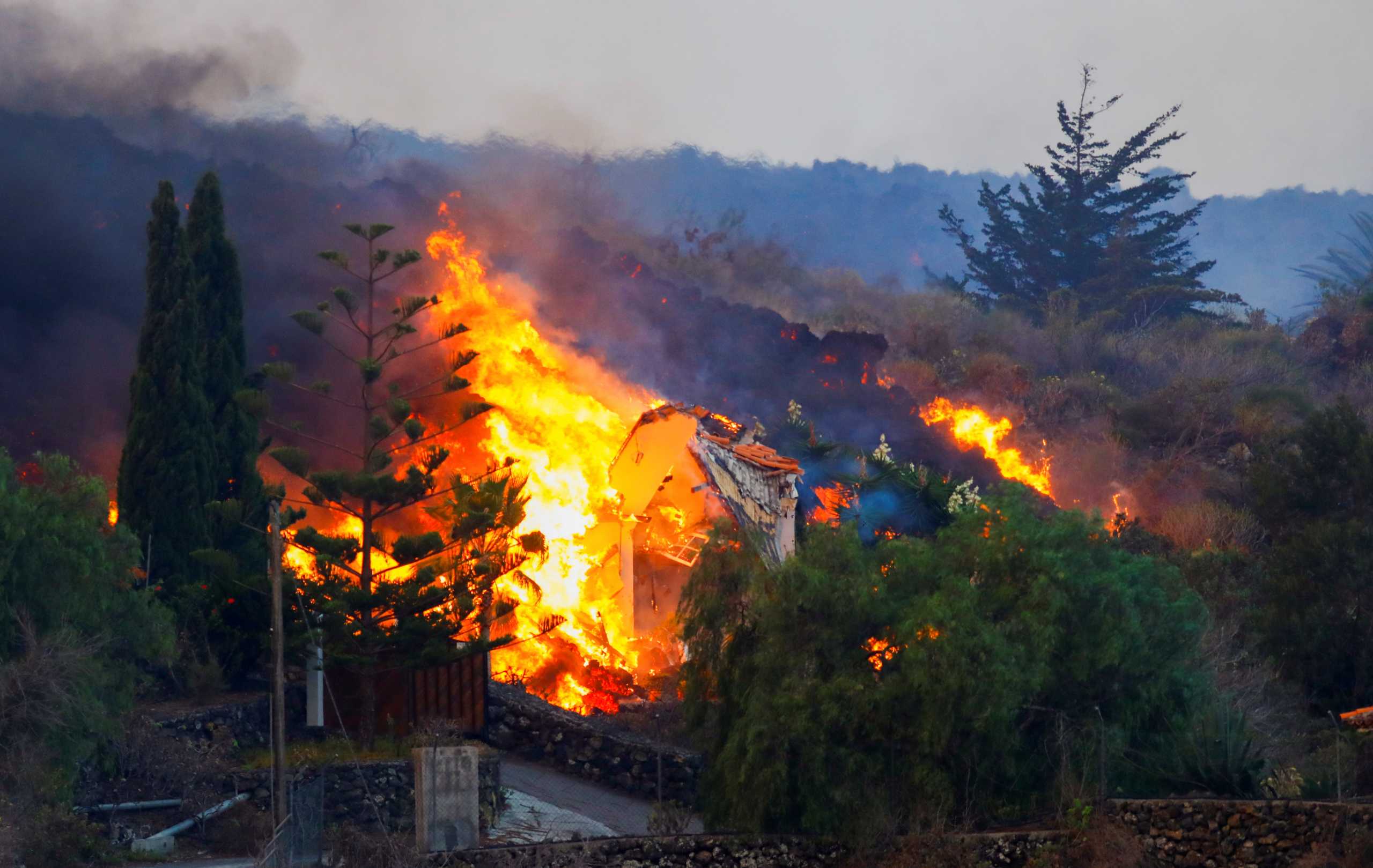 A house burns due to lava from the eruption of a volcano in the Cumbre Vieja national park at Los Llanos de Aridane, on the Canary Island of La Palma, September 20, 2021. REUTERS