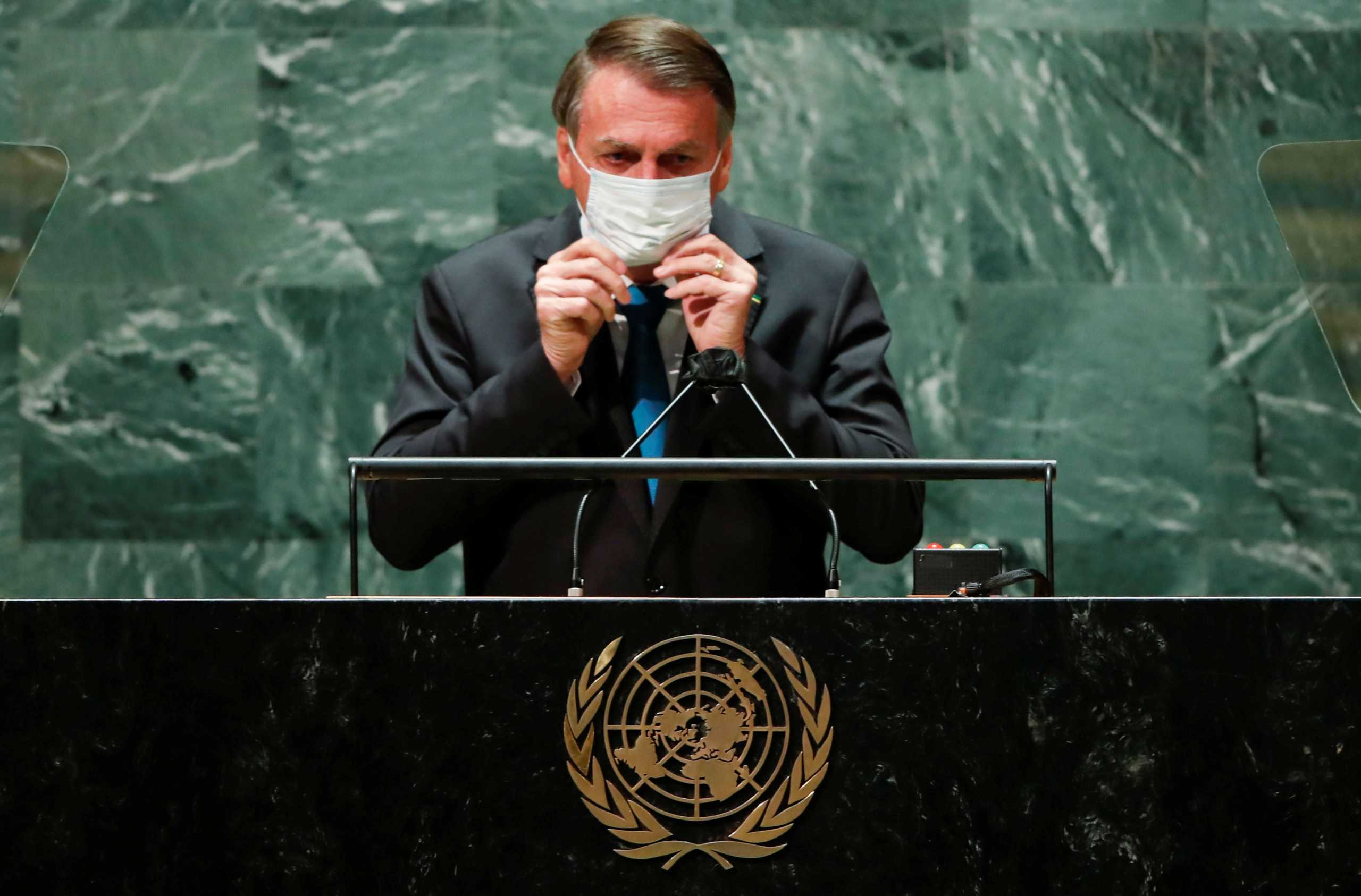 Brazil's President Jair Bolsonaro puts back on a protective face mask worn due to the coronavirus disease (COVID-19) pandemic after speaking during the 76th Session of the U.N. General Assembly in New York City, U.S., September 21, 2021.  REUTERS