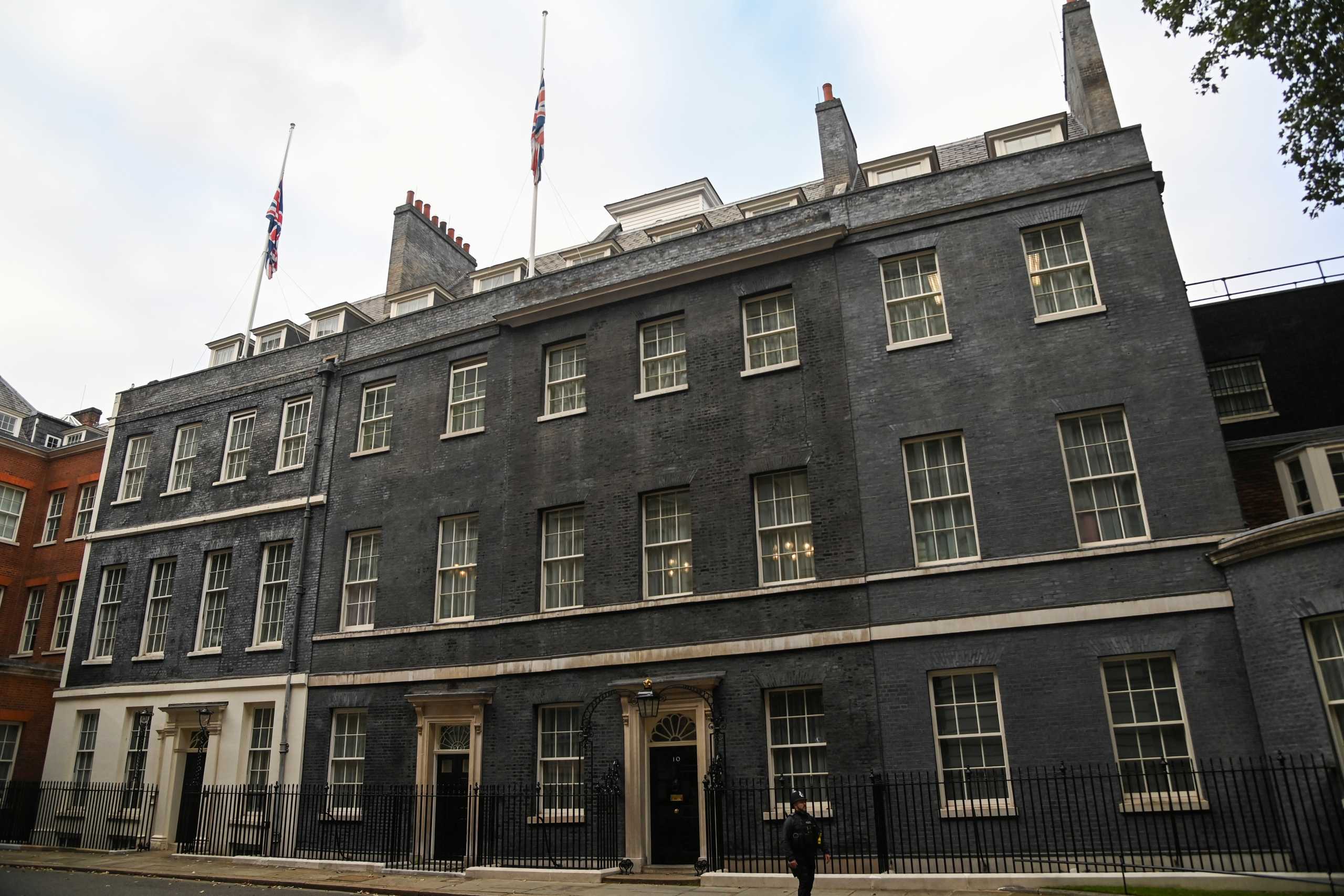 Flags are seen at half mast after MP David Amess was stabbed during constituency surgery, on the roof of 10 Downing Street, London, Britain October 15, 2021. REUTERS