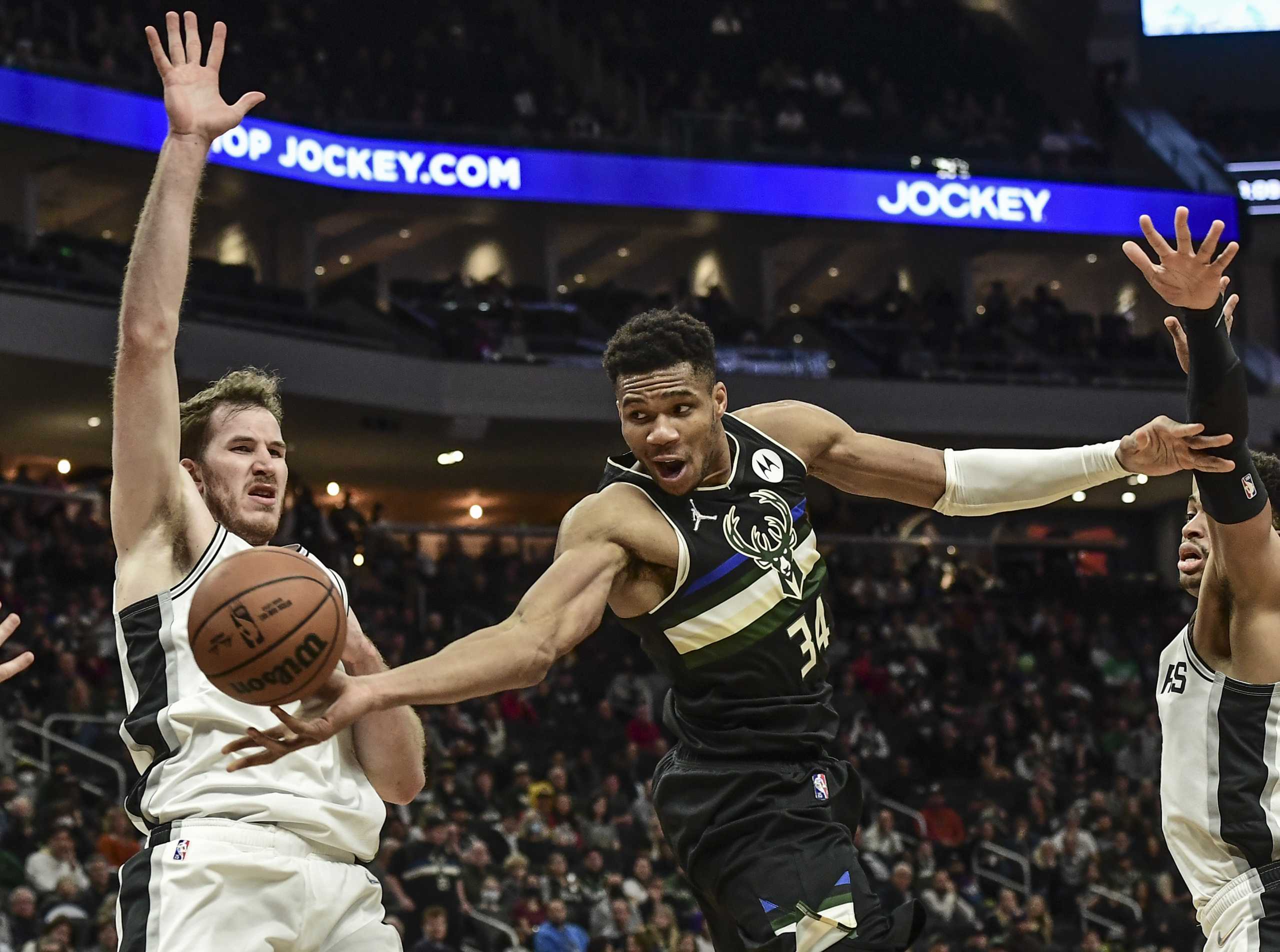 Oct 30, 2021; Milwaukee, Wisconsin, USA; Milwaukee Bucks forward Giannis Antetokounmpo (34) passes the ball away from San Antonio Spurs center Jakob Poeltl (25) in the fourth quarter at Fiserv Forum. Mandatory Credit: Benny Sieu-USA TODAY Sports