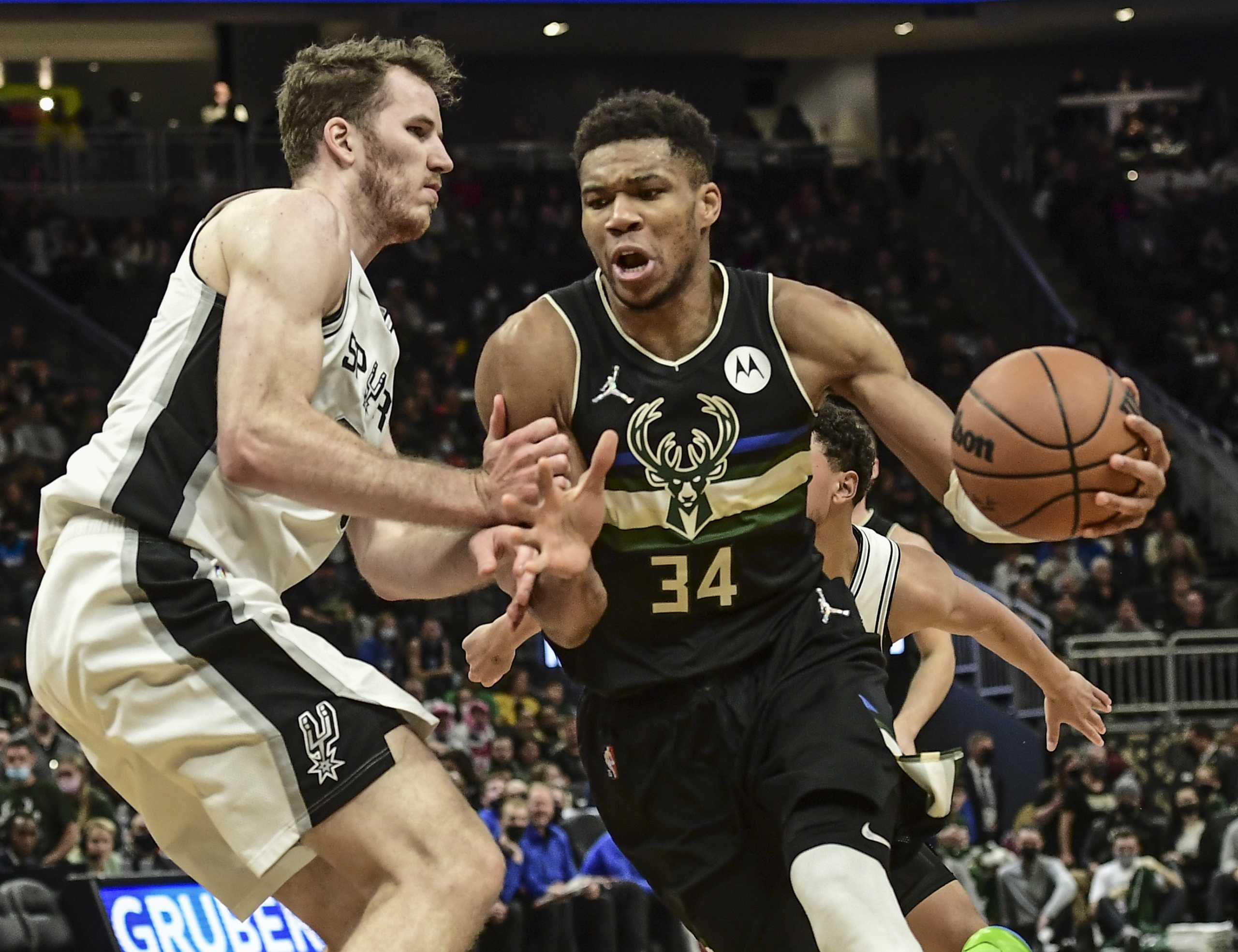 Oct 30, 2021; Milwaukee, Wisconsin, USA; Milwaukee Bucks forward Giannis Antetokounmpo (34) drives for the basket against San Antonio Spurs center Jakob Poeltl (25) in the fourth quarter at Fiserv Forum. Mandatory Credit: Benny Sieu-USA TODAY Sports