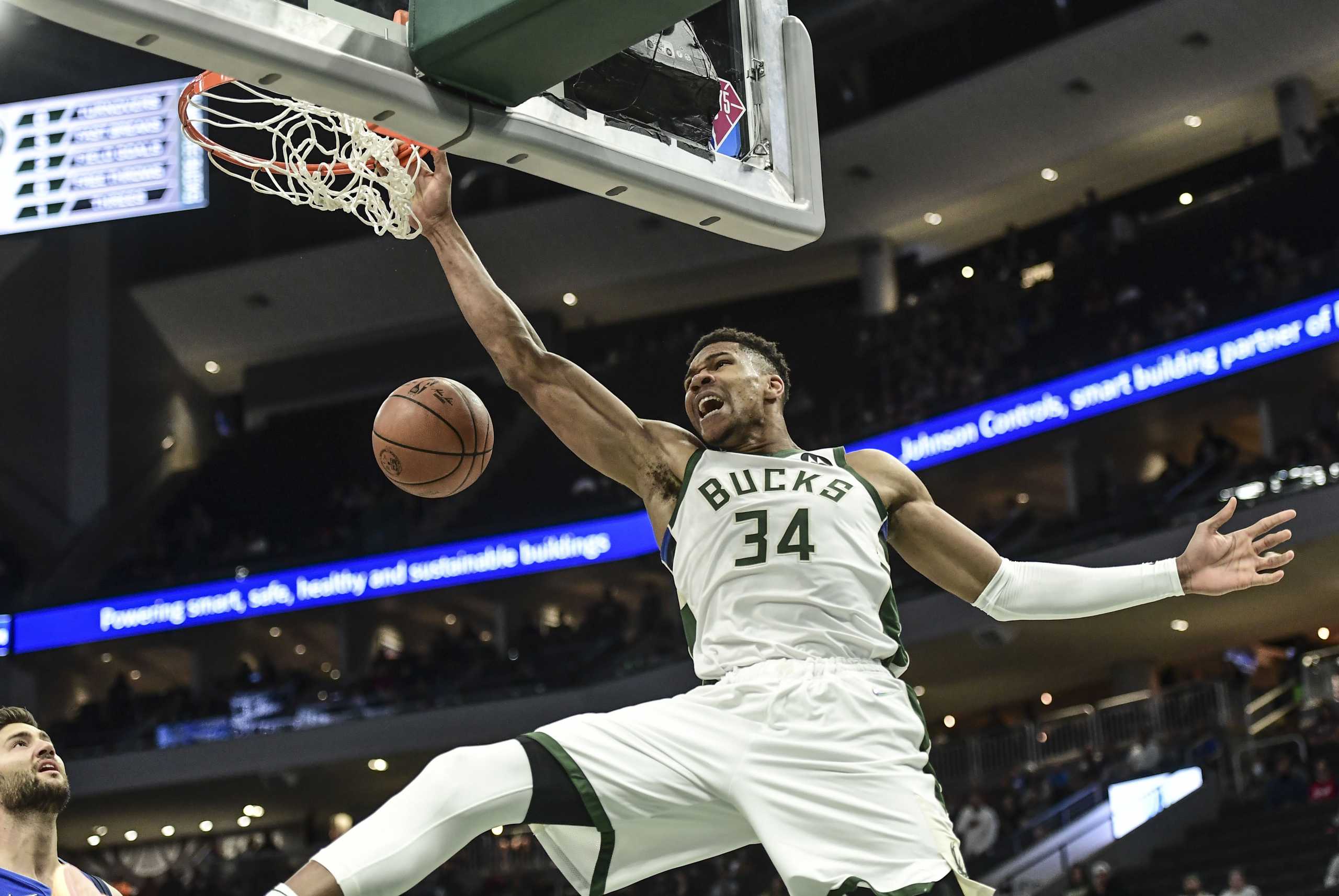 Oct 15, 2021; Milwaukee, Wisconsin, USA; Milwaukee Bucks forward Giannis Antetokounmpo (34) dunks a basket in the first quarter during the game against the Dallas Mavericks  at Fiserv Forum. Mandatory Credit: Benny Sieu-USA TODAY Sports