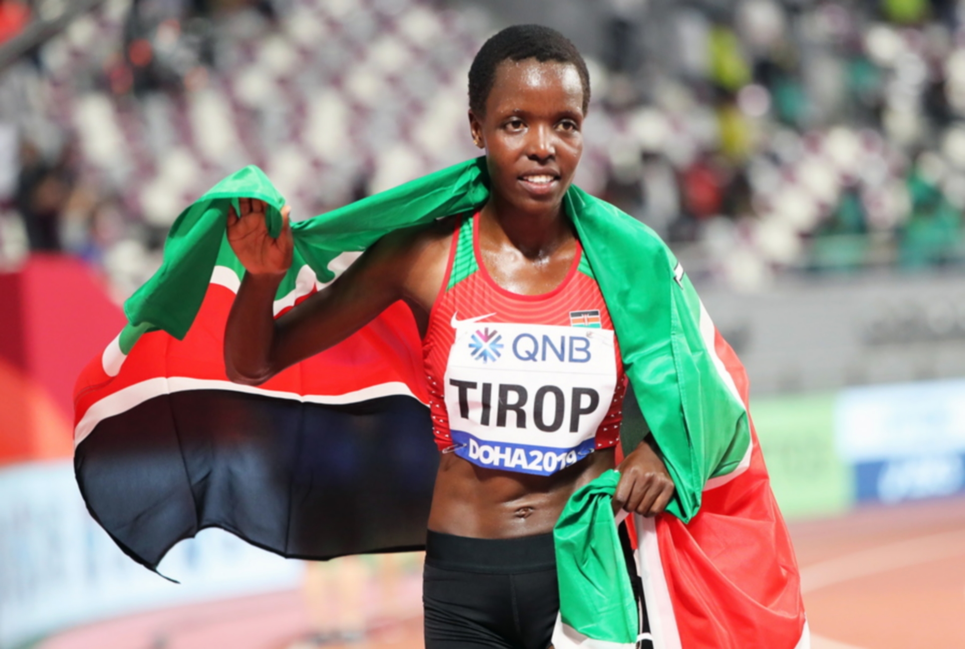 epa07878182 Agnes Jebet Tirop of Kenya celebrates after taking the third place in the women's 10,000m final during the IAAF World Athletics Championships 2019 at the Khalifa Stadium in Doha, Qatar, 28 September 2019. EPA