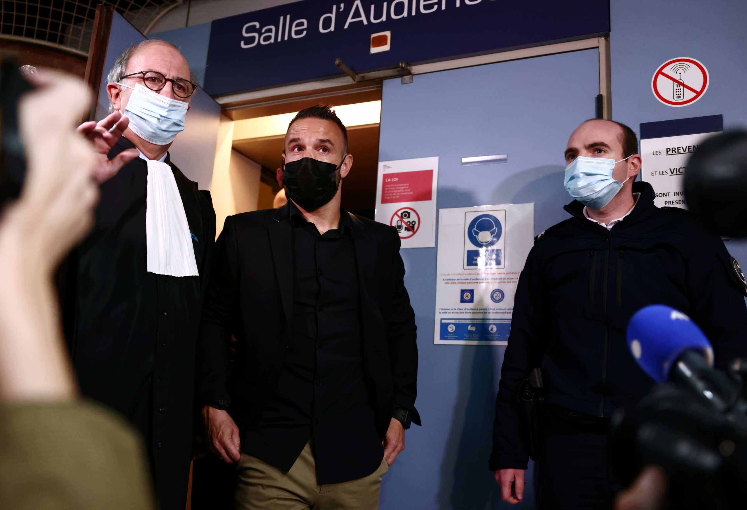 French soccer player Mathieu Valbuena and his lawyer Paul-Albert Iweins answer questions to journalists during a break in the trial of Real Madrid soccer team player Karim Benzema and other defendants, on charges of involvement in an alleged attempt to blackmail Valbuena over a sex tape almost five years ago, at the Versailles courthouse, near Paris, France, October 20, 2021. REUTERS
