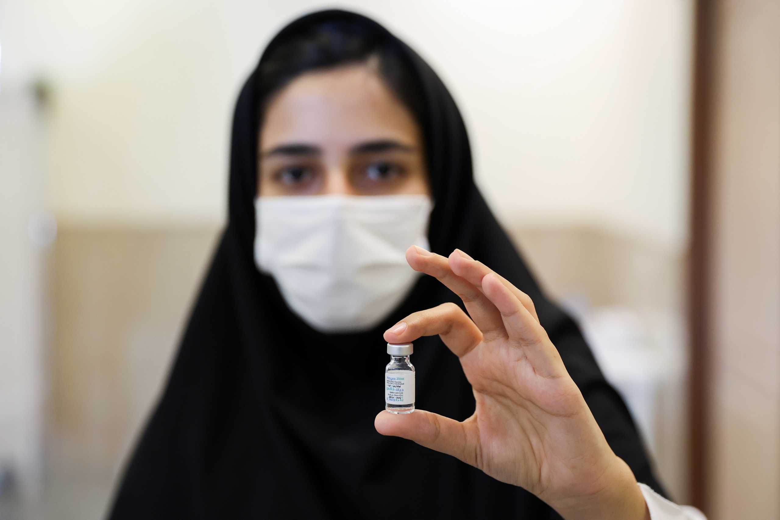 A medical worker displays a vial of a vaccine against the coronavirus disease (COVID-19) at a school in Tehran, Iran, October 7, 2021. Majid Asgaripour