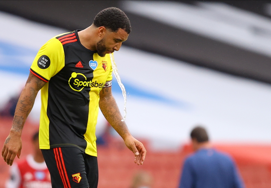 epa08567431 Watford's Troy Deeney spits water during the English Premier League match between Arsenal London and Watford in London, Britain, 26 July 2020.  EPA
