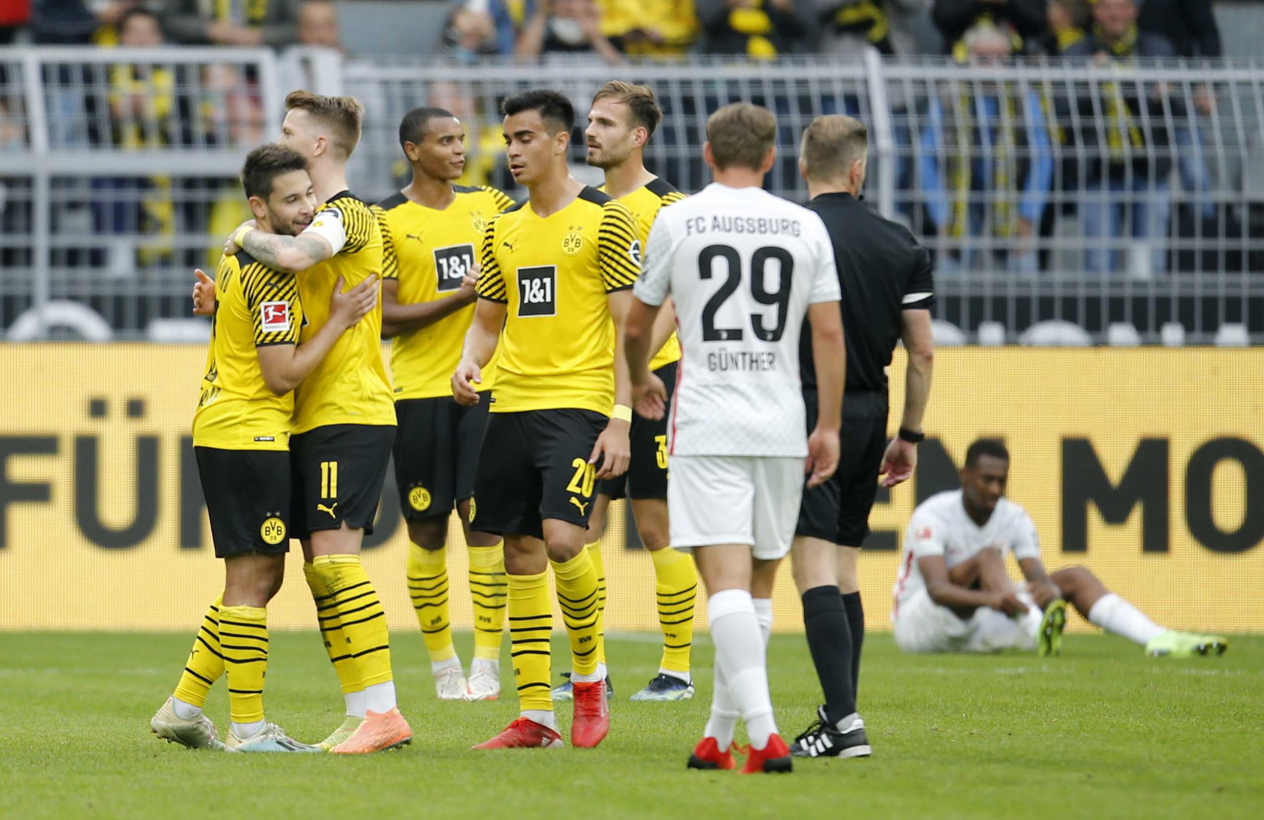 Soccer Football - Bundesliga - Borussia Dortmund v FC Augsburg - Signal Iduna Park, Dortmund, Germany - October 2, 2021 Borussia Dortmund's Raphael Guerreiro and Marco Reus celebrate after the match REUTERS